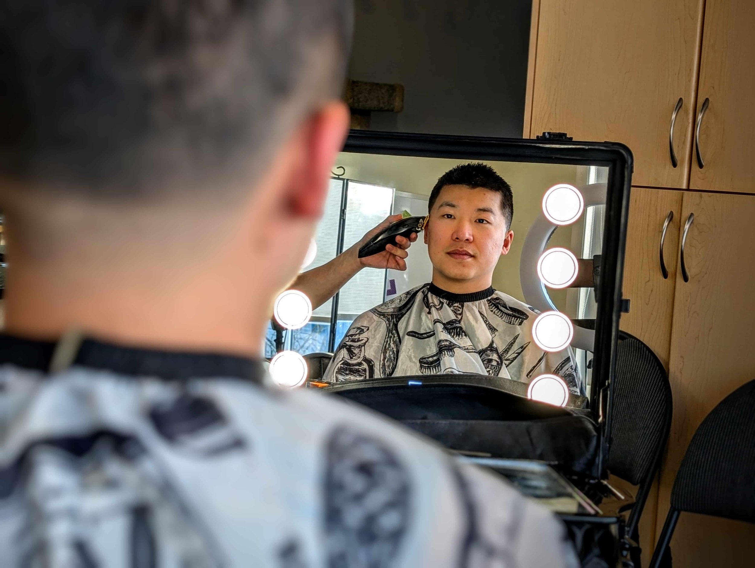 Portrait of a friendly barber preparing to cut hair at home