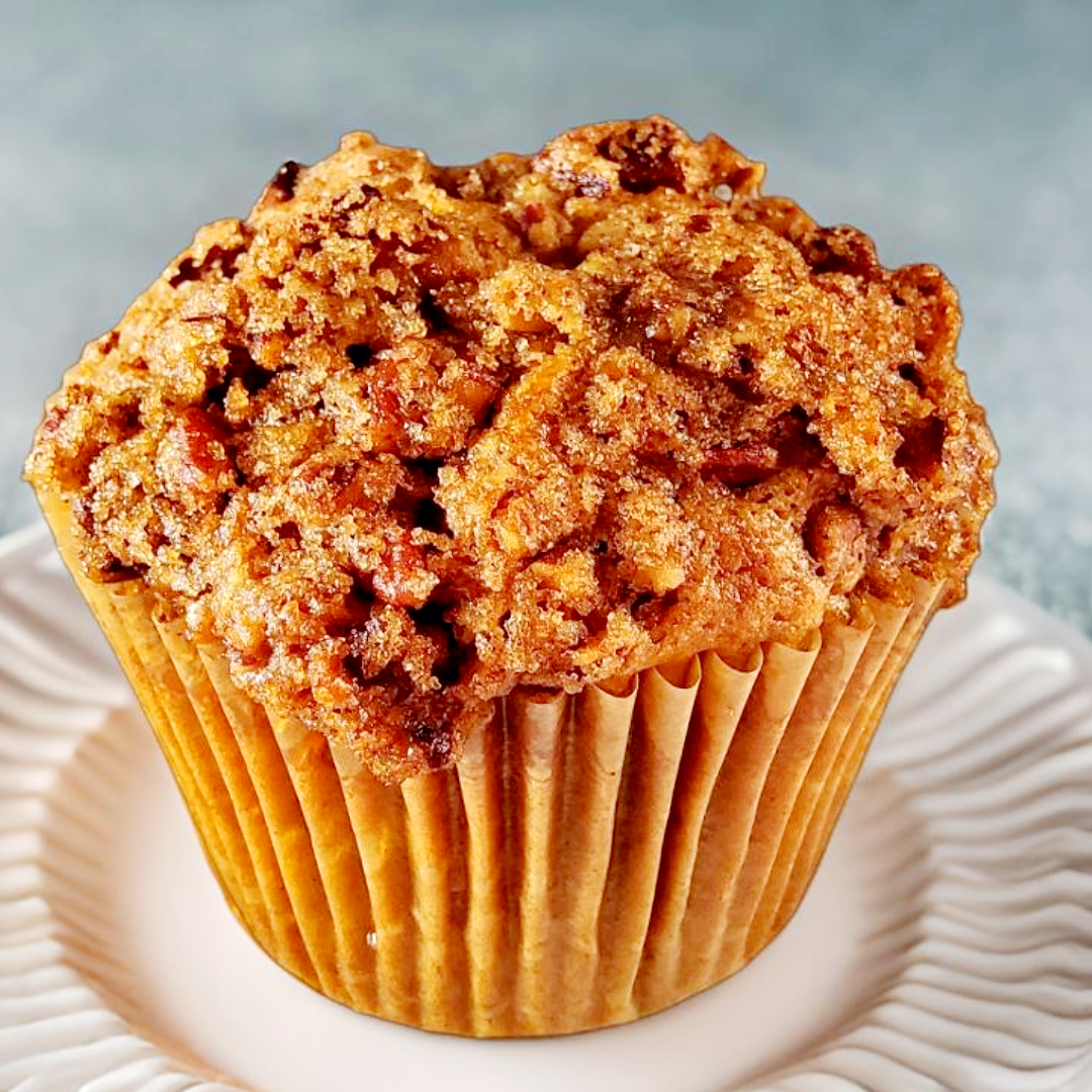 plant-based sweet potato muffin topped with cinnamon brown sugar and pecan streusel