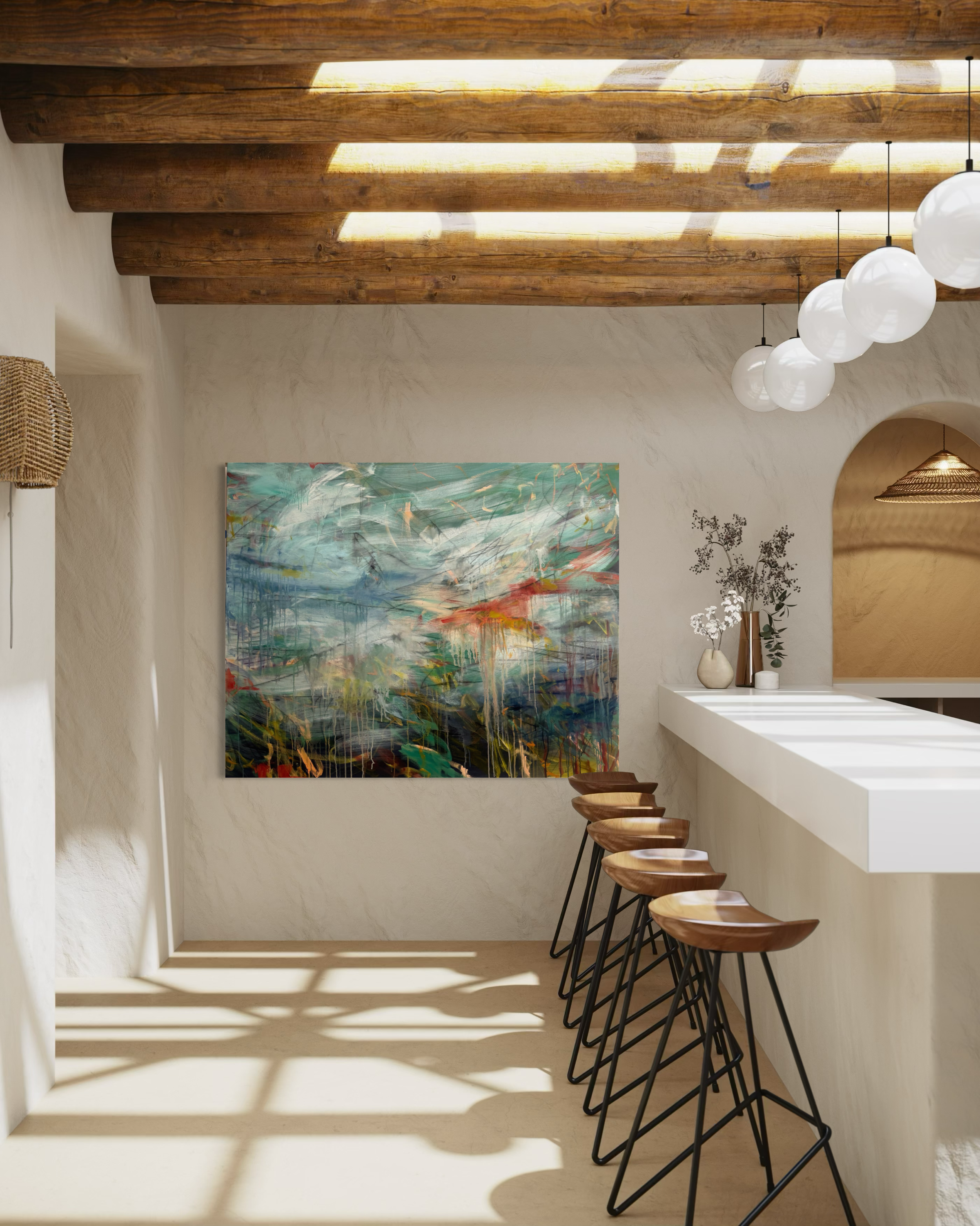 Interior of a modern space with wooden ceiling beams, a white bar counter with four wooden bar stools, a colorful abstract painting on the wall, and decorative vases with branches on the counter. Sunlight filters through a window creating shadows on the floor.