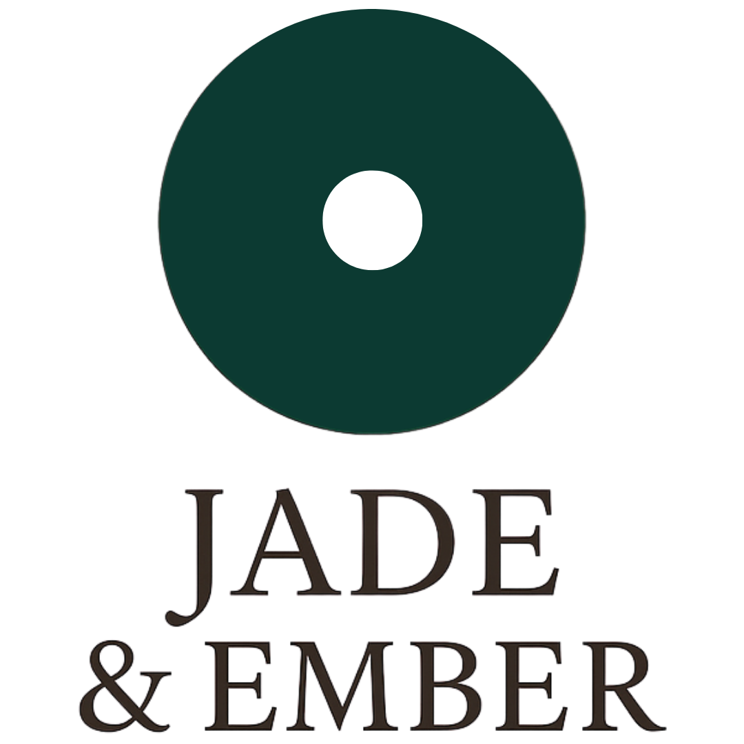 A stylized dark green circle with a white smaller circle inside, resembling a minimalist eye or record. Below, the text reads 'JADE & EMBER' in dark, elegant font.