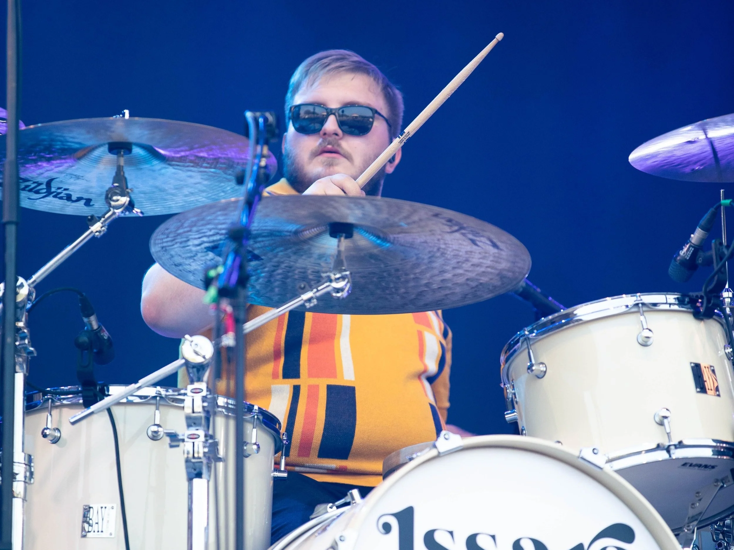 Jack Bowman performing drums live on stage.