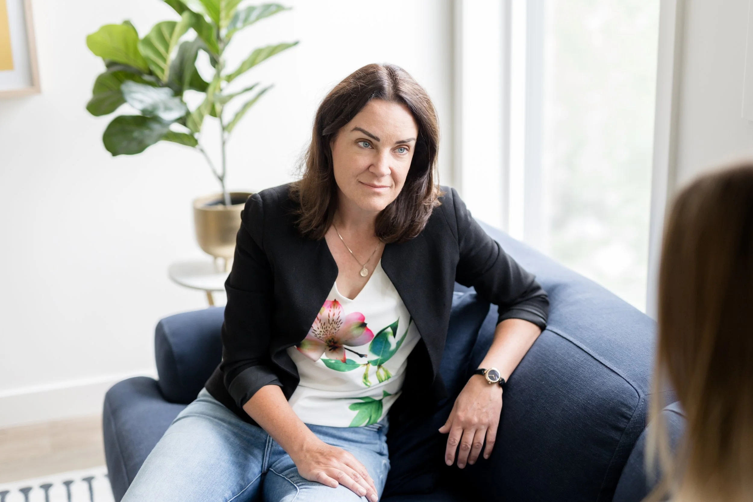 Therapist offering grounded, supportive presence during a session about mental load and emotional labour.