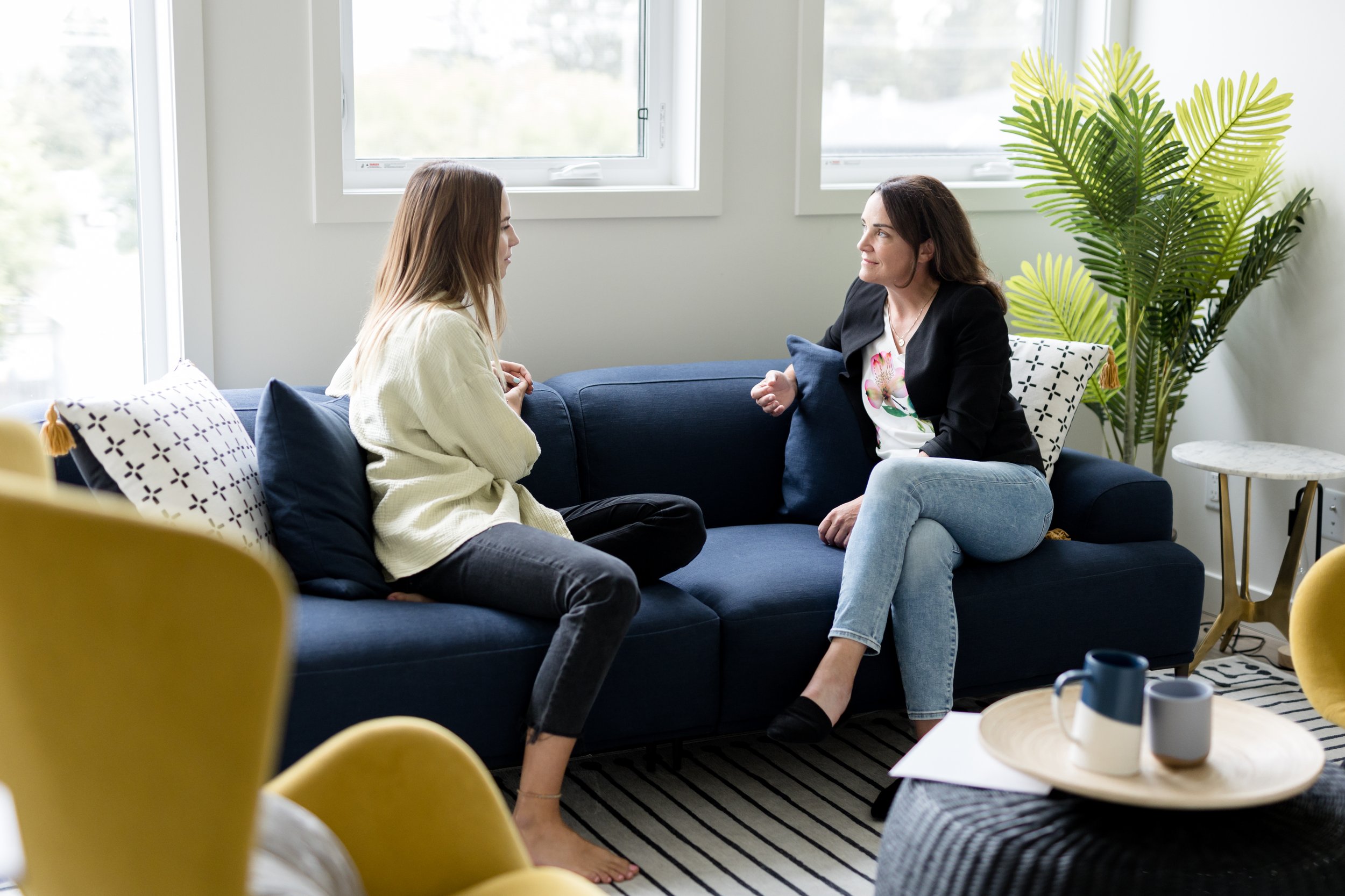 Psychologist conducting a psychological assessment consultation with a client in Calgary, discussing ADHD, autism, learning, and psychoeducational assessment services at NU Psychology.