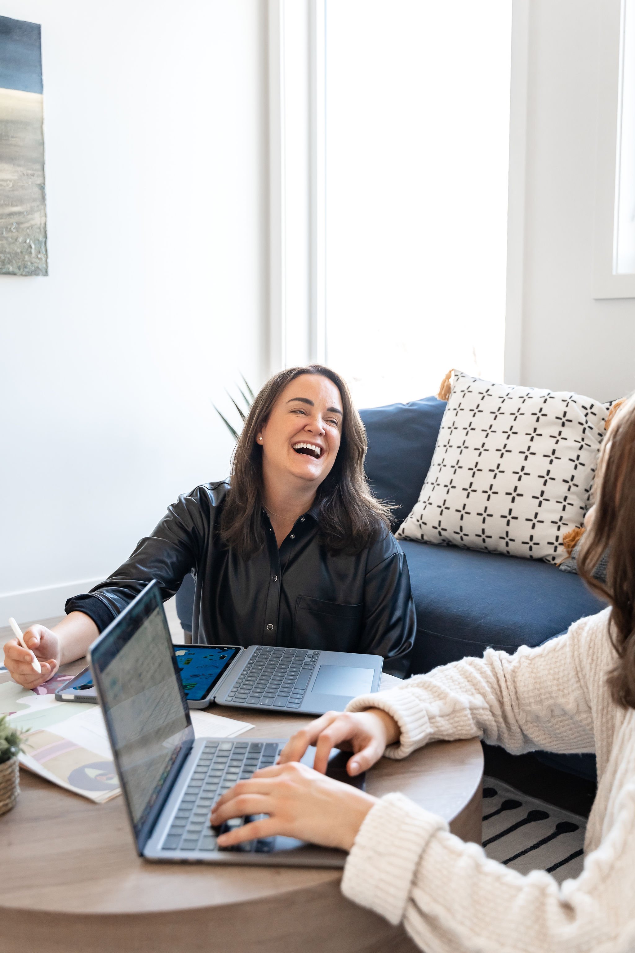 Client sharing a light moment in therapy while exploring stress and emotional overload.