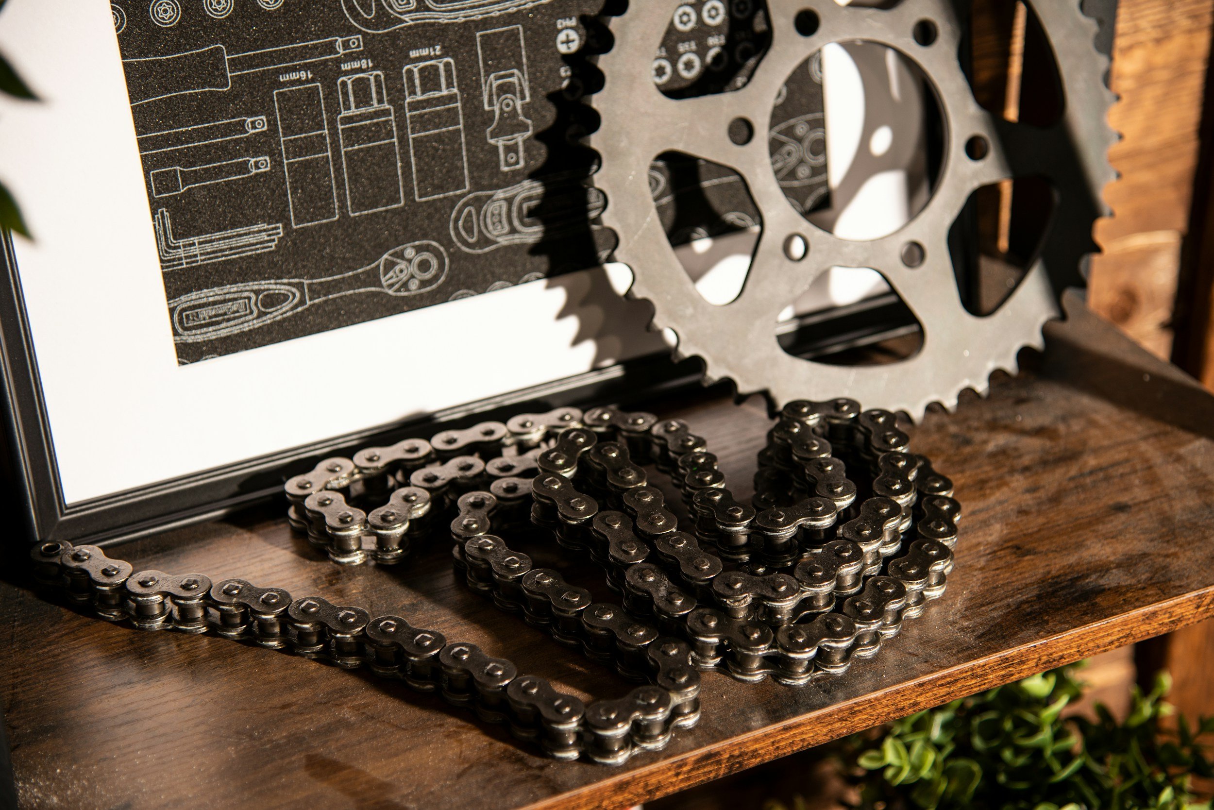 A chain, gear, and blueprint sitting on a table
