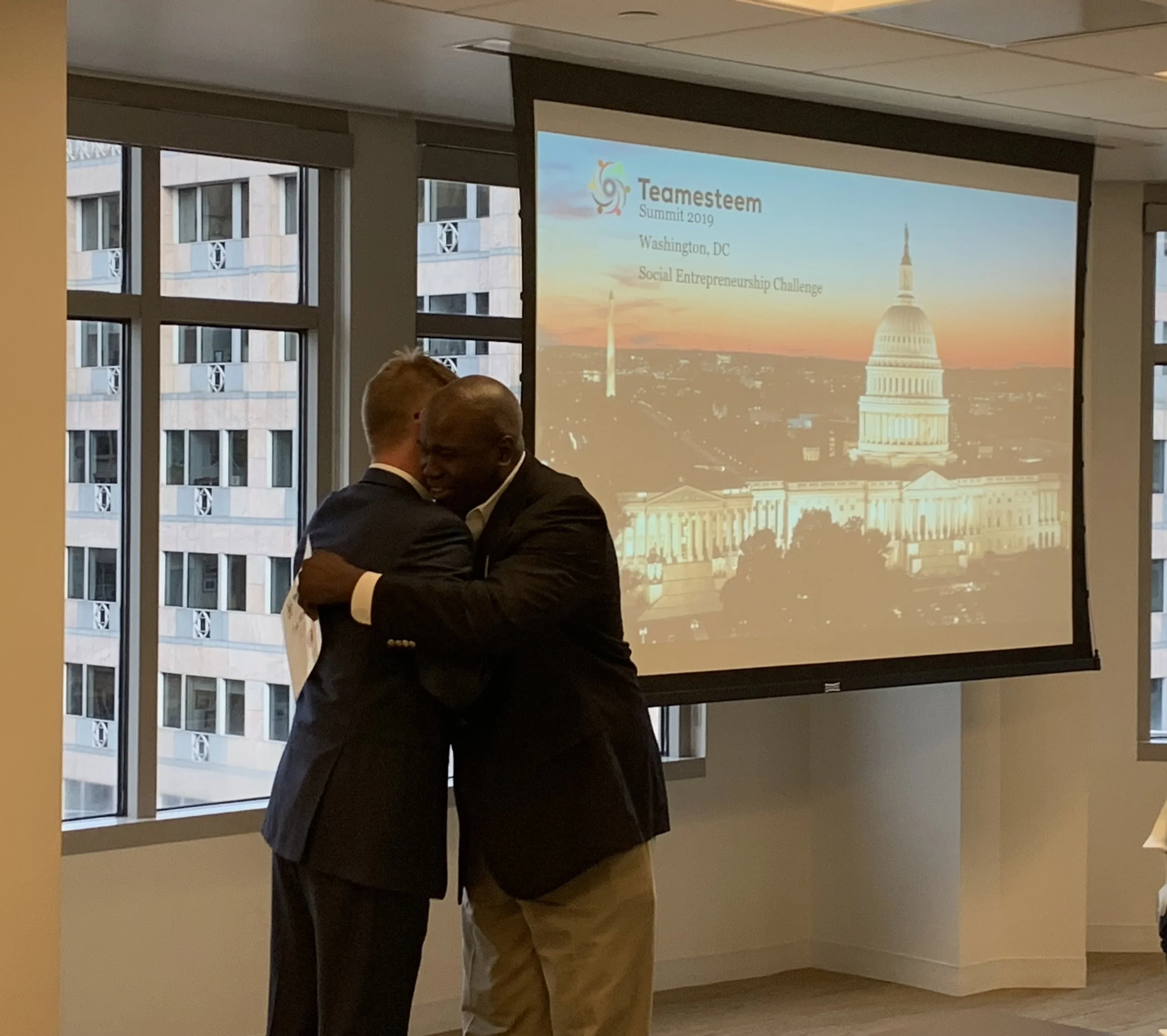 Presentation of a special award followed by a warm embrace of friendship.
