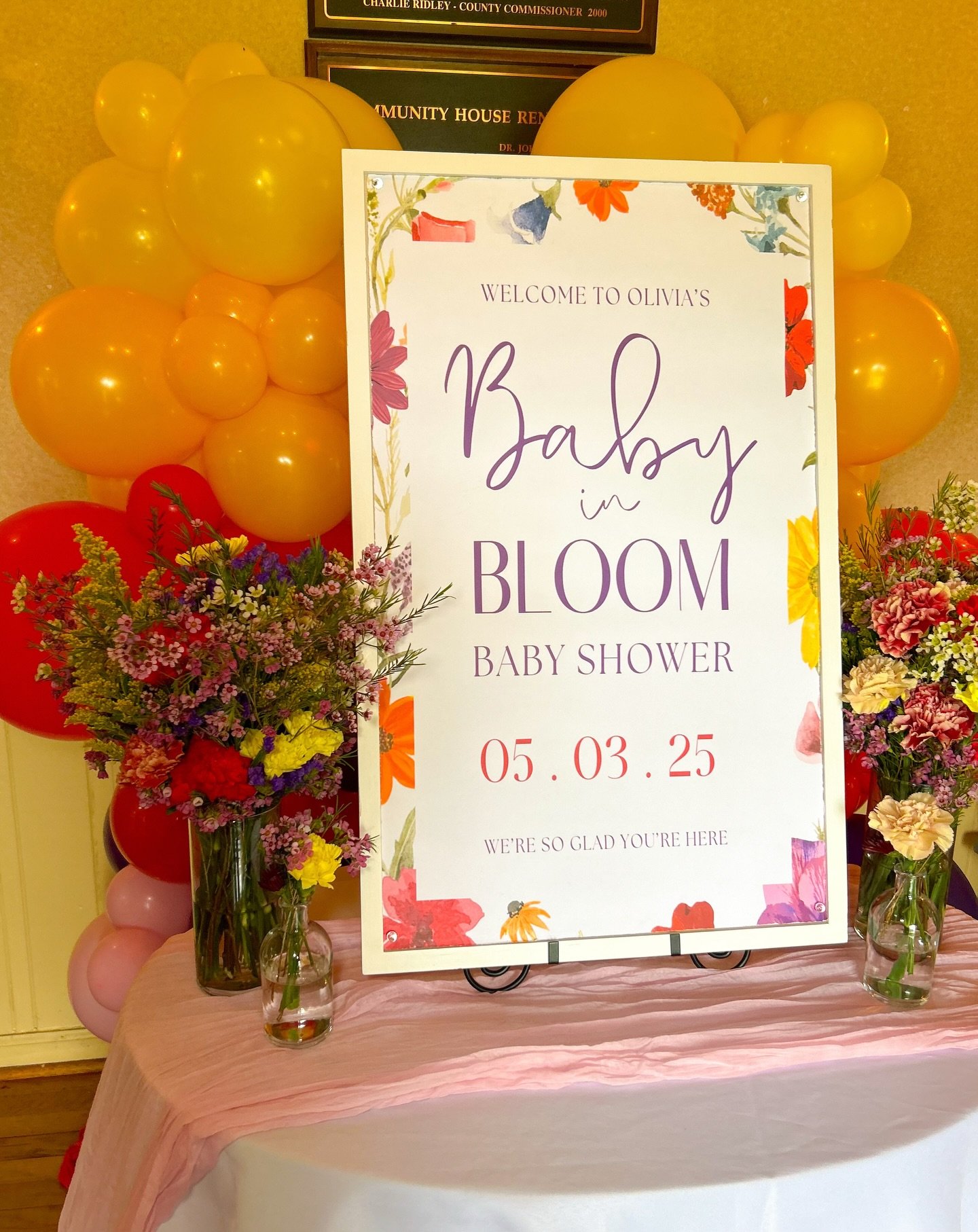 May 3, 2025: Inside, guests were welcomed by a gorgeous sign, two Signature Arrangements, and two Petite Arrangements. Turning left from the welcome table, guests found food, drinks, and an array of tasty treats. Tiny Balloon Towers and Petite Arrang