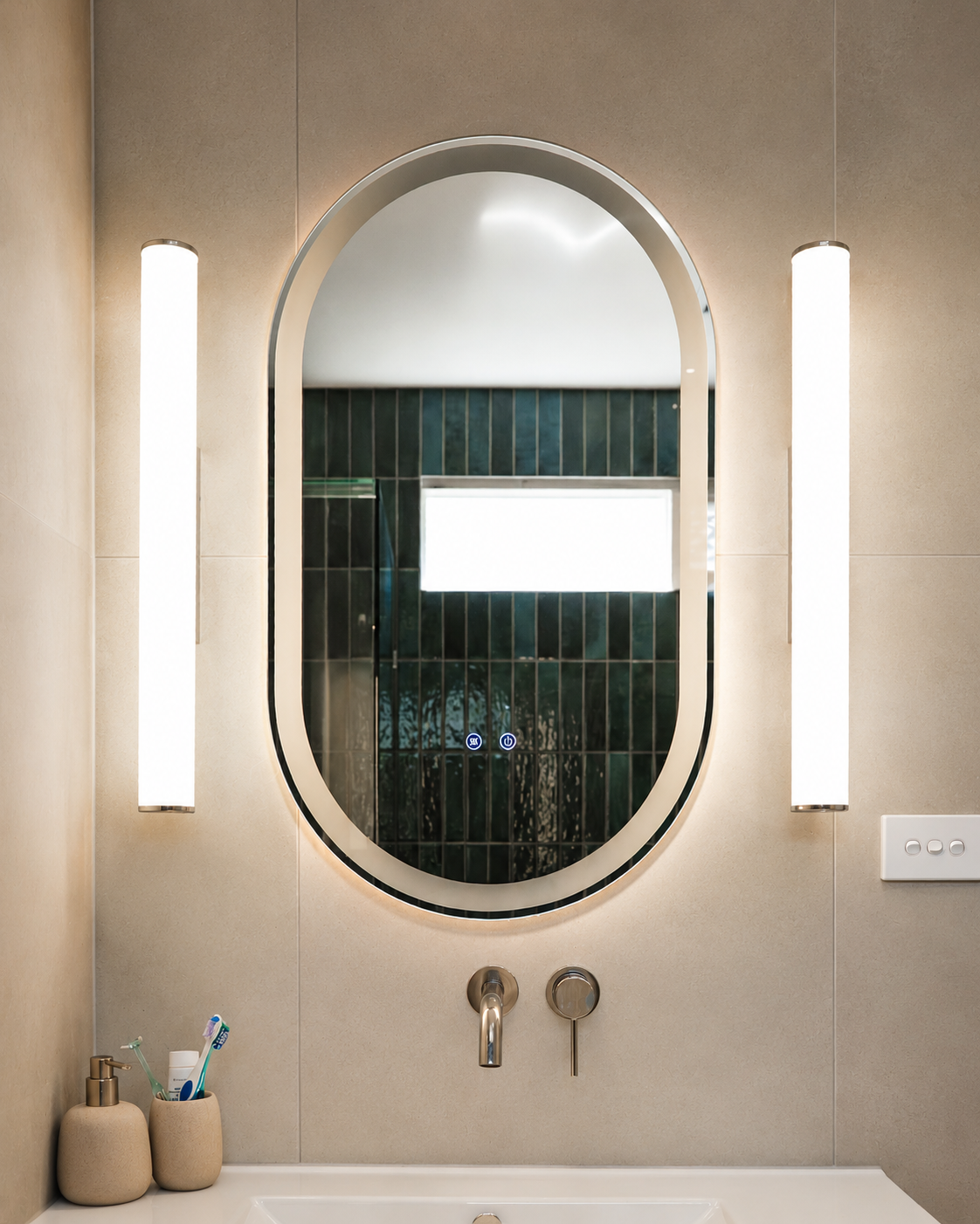 Oval backlit vanity mirror with slim wall lights over the ensuite basin, Yarraville renovation by Lúrae Studio