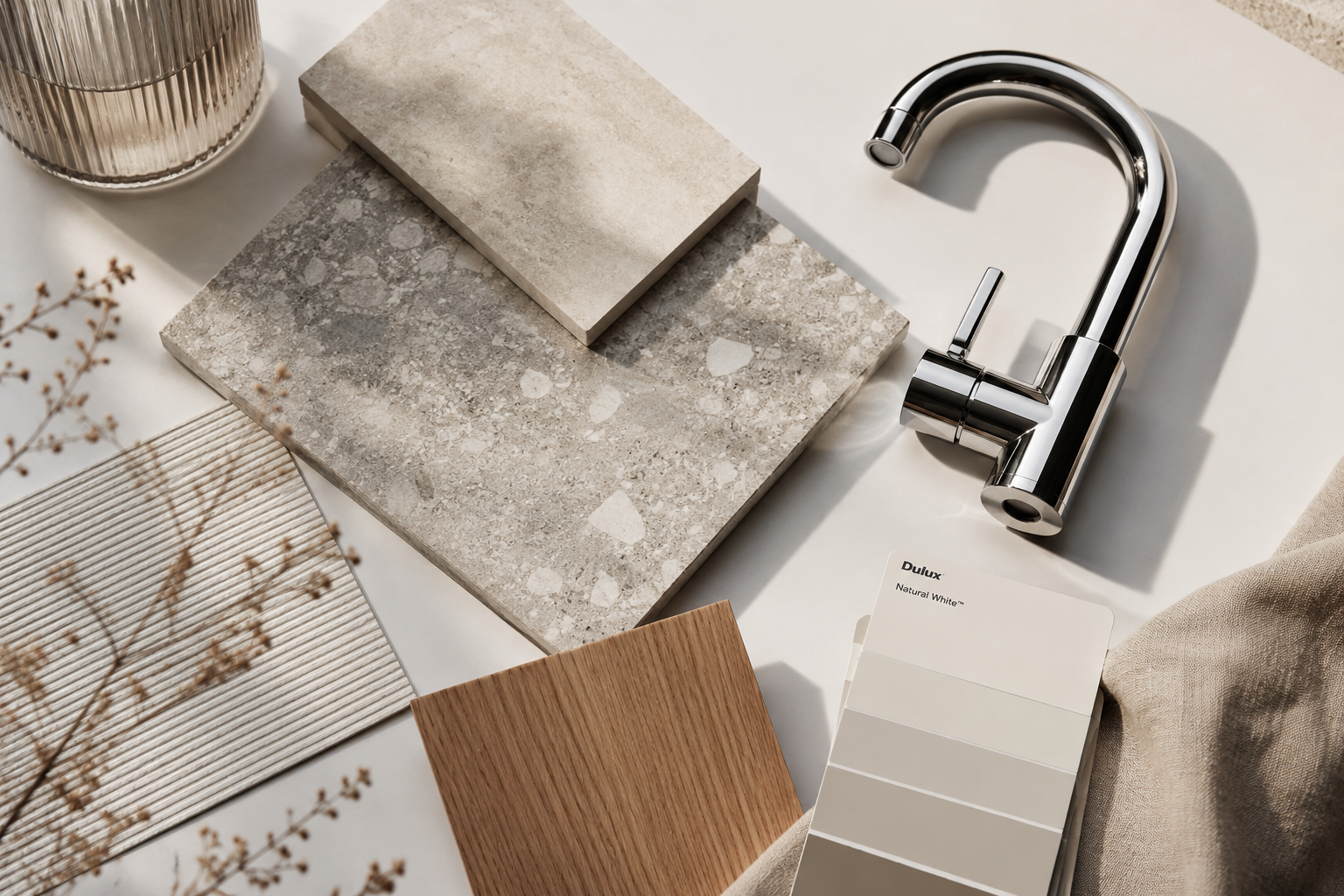 Interior material samples including tiles, tapware and timber laid out for a renovation project