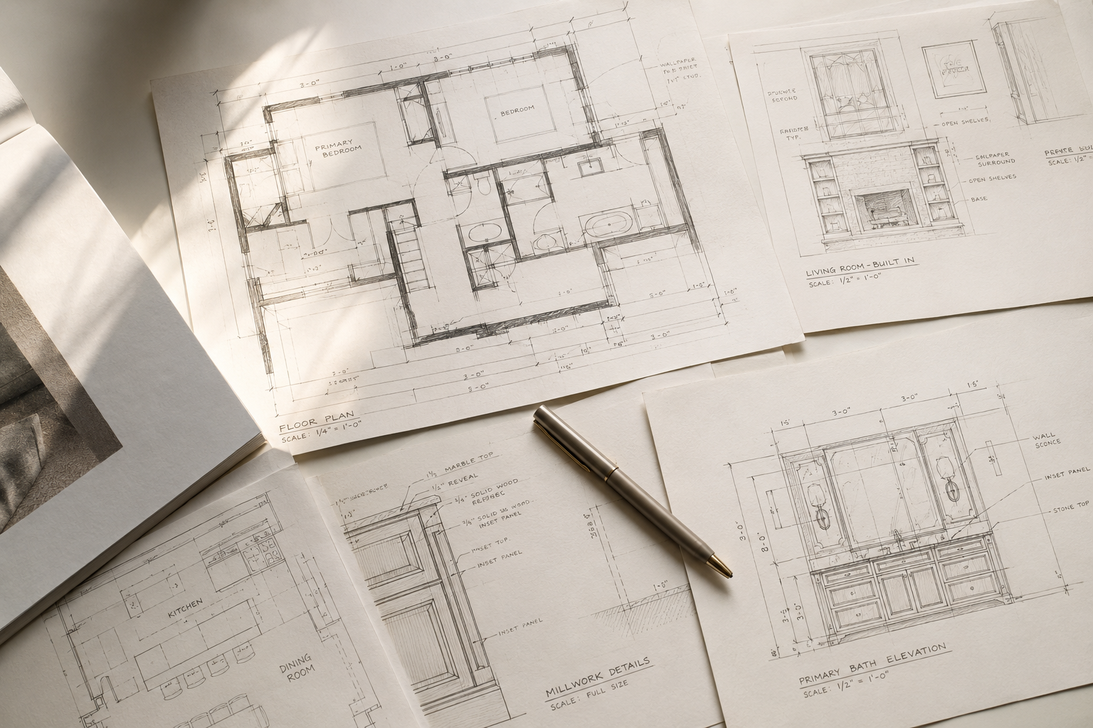 Detailed interior design drawings and floor plans laid out on a desk