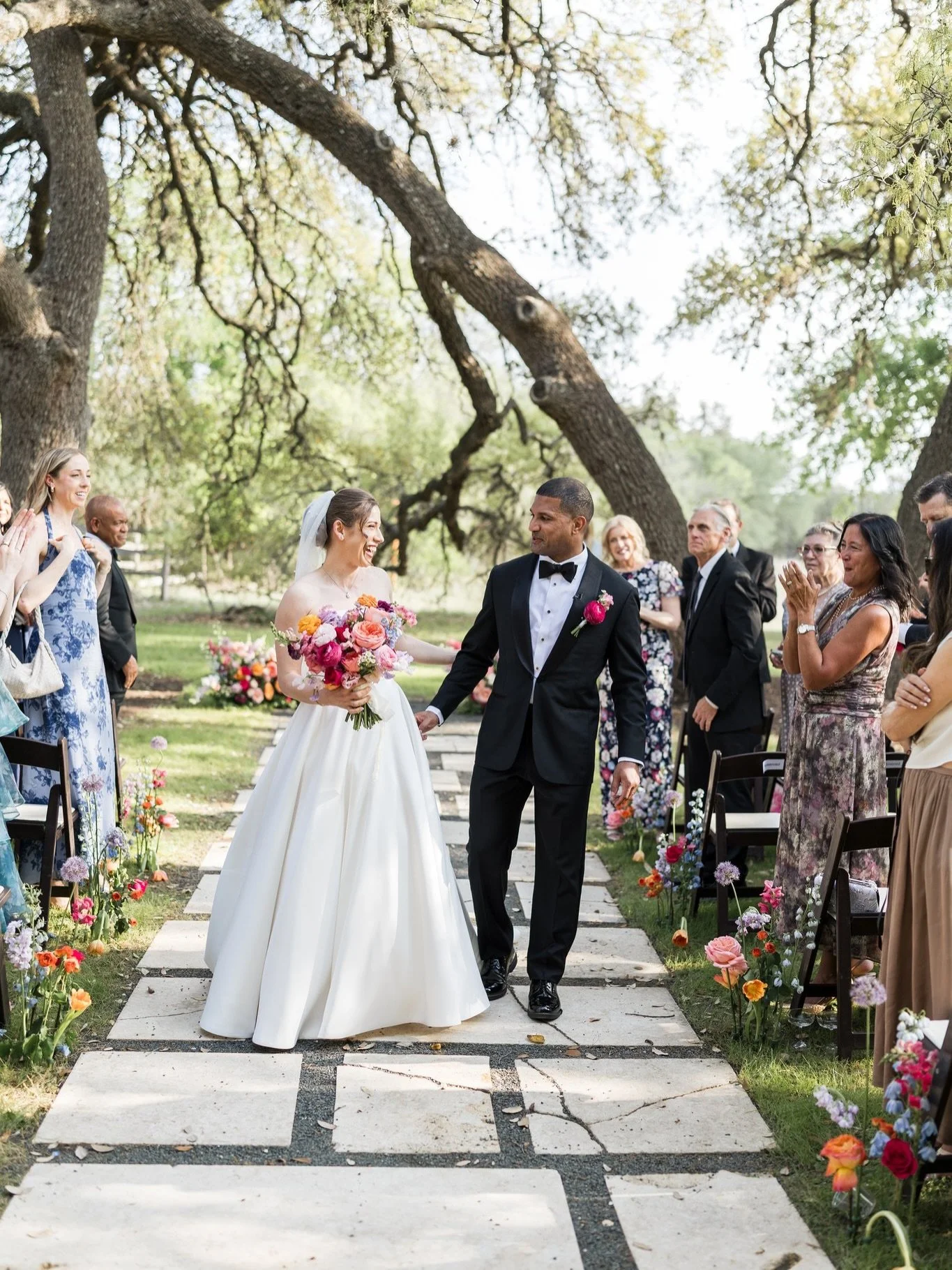 Haleigh &amp; Wilson 💍 A couple full of joy and flowers to match. 💐

Vibrant garden roses, ranunculus, and allium in every shade of pink, purple, and orange lining the aisle at Vineyard at Chapel Lodge. The goal was joyful, abundant, and colorful. 