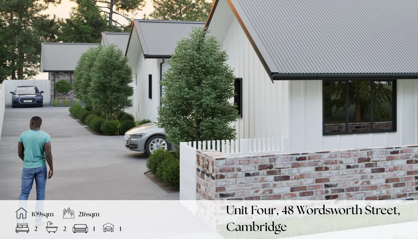 Exterior view of modern residential houses with gray roofs, white siding, and landscaped yard, showing a man walking on driveway near parked cars, with trees and greenery in the background.
