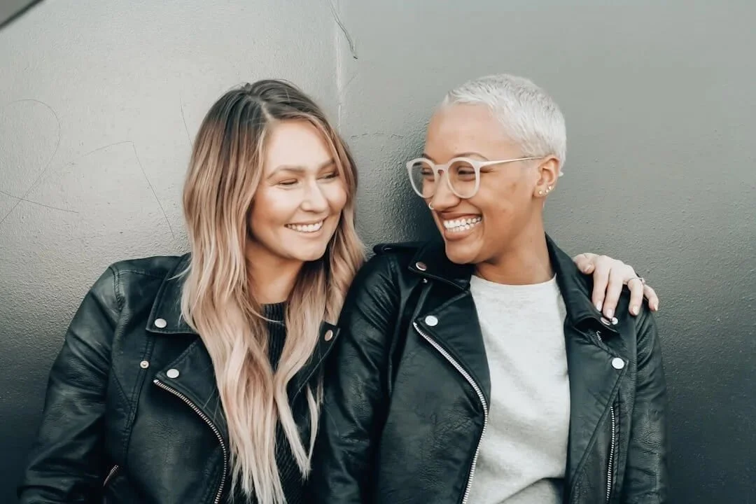 bipoc therapist orange county two people wearing leather jackets smiling at each other