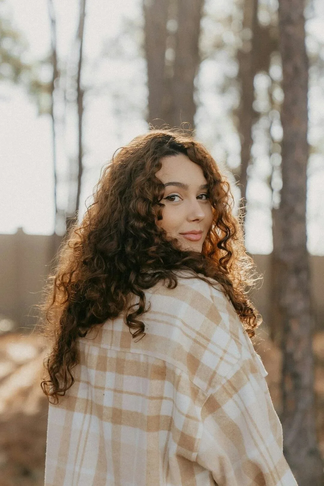 counseling for women of color california person with curly brown hair is looking back at camera with slight smile