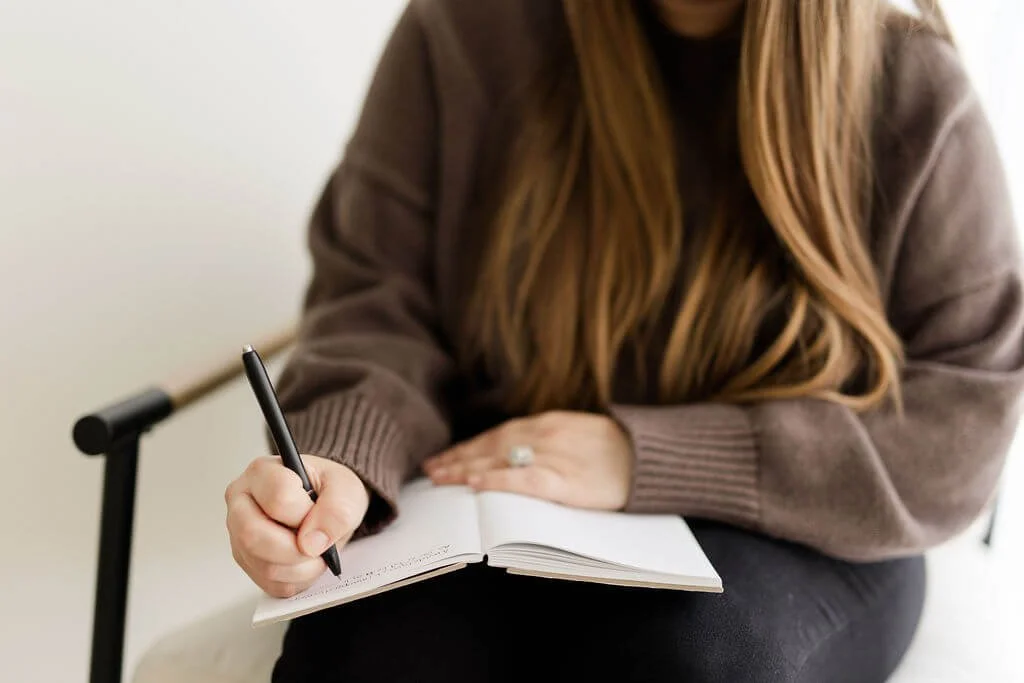 natalia michaelson orange county bipoc therapist writing in notebook
