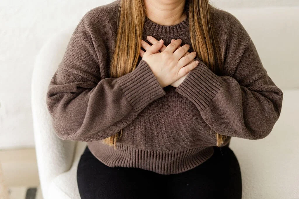 ifs therapist oc person brown sweater black pants hand over heart