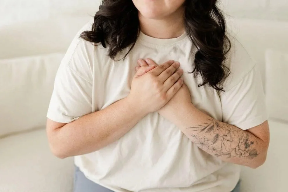 ifs therapist orange county person with hands over heart floral tattoo on left forearm