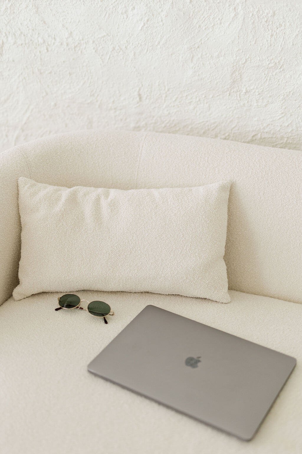 therapist in orange county white couch sunglasses closed gray laptop