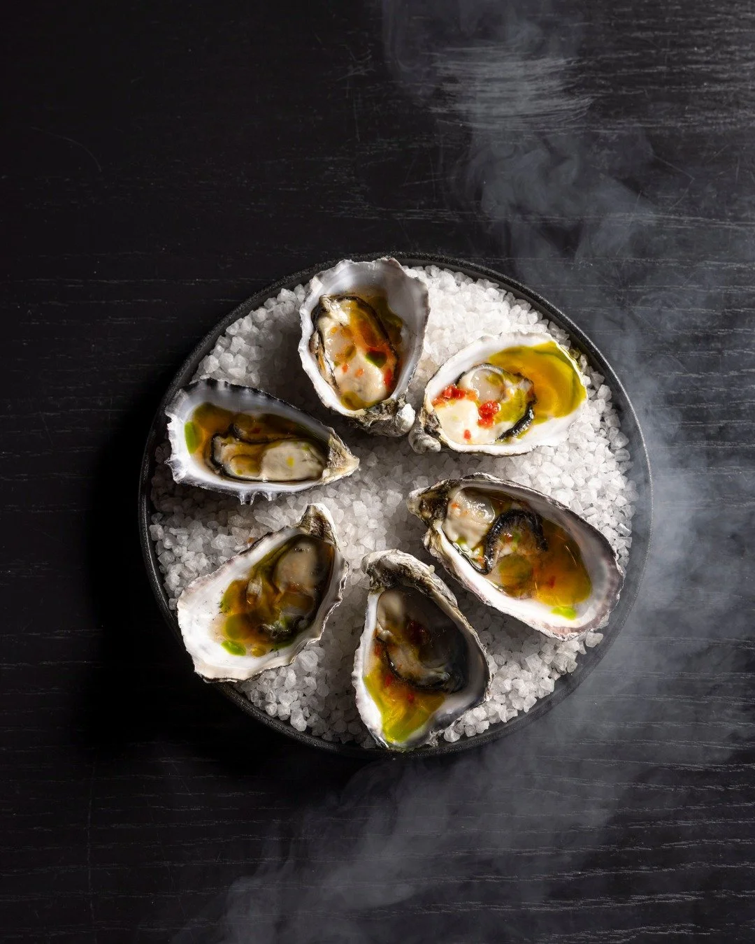 Spring heat calls for something clean, sharp, and cool – and oysters do it best. 
Our Pacific Oysters arrive dressed with spicy nuoc cham for a Vietnamese edge, tomato essence for light acidity, and dill oil for a smooth finish. It’s sea