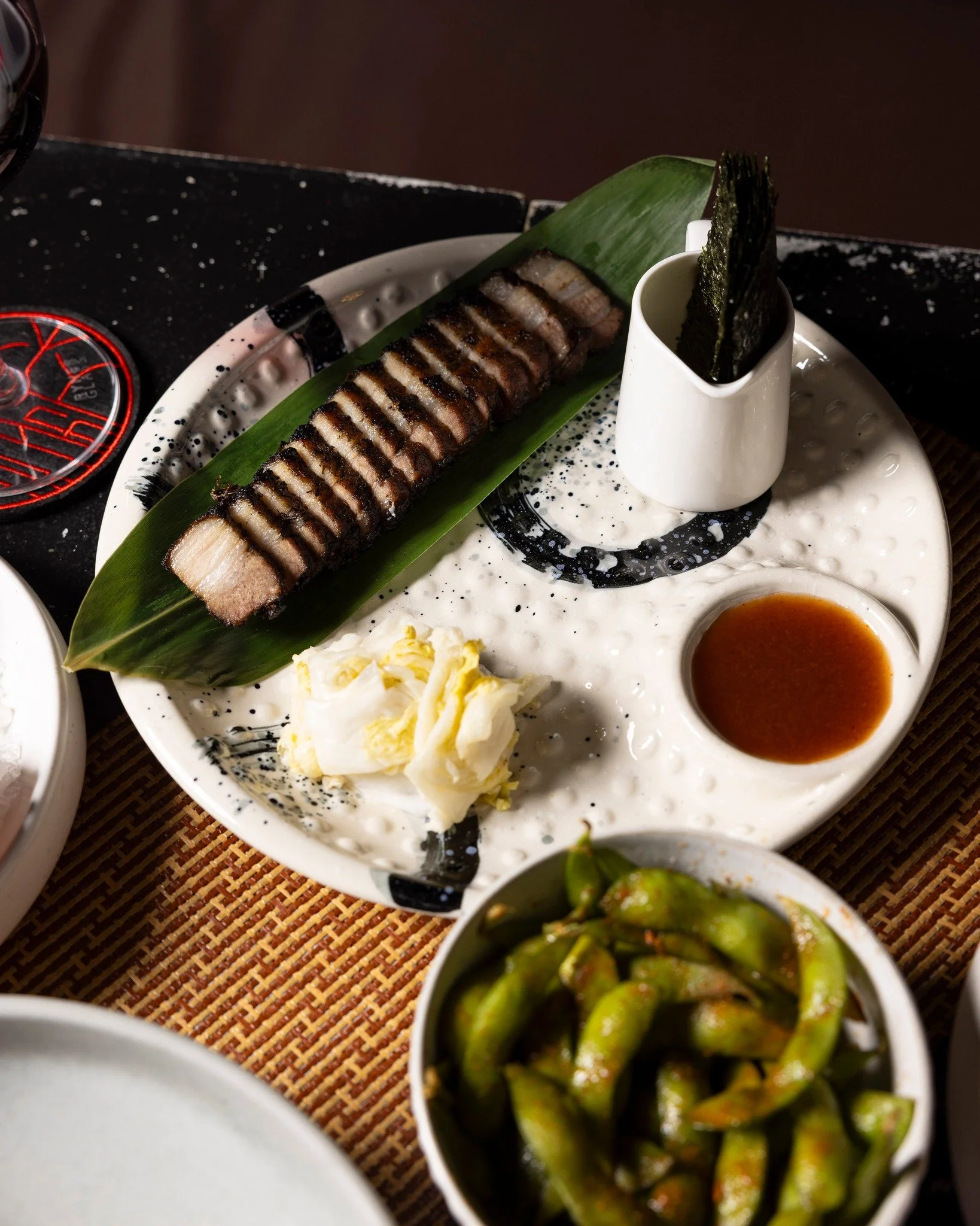 The Pork Belly at Kaiza is charcoal-kissed, slow-cooked, and built on techniques shaped by Japanese structure and Vietnamese comfort. 

Paired with fresh edamame, it&rsquo;s a simple dish made with clear intention. It works just as well for solo dine