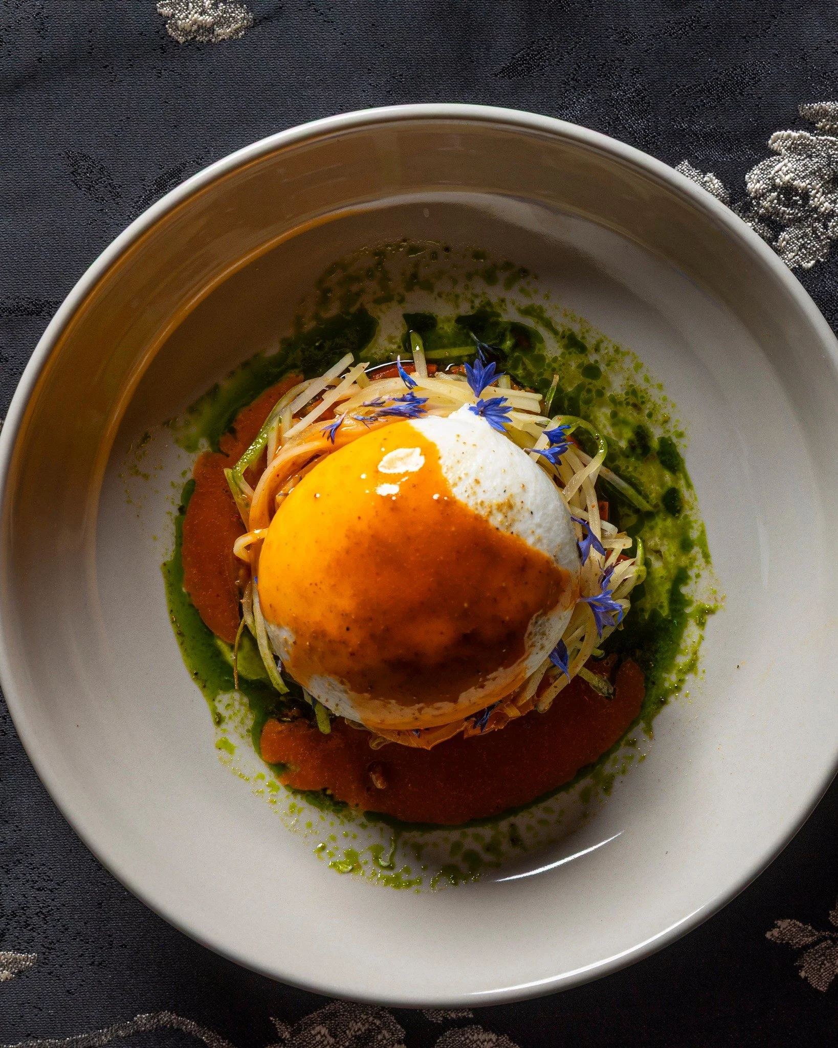 Some dishes explain the menu better than words.

The burrata pairs shoyu apricot vinaigrette with oxheart tomato, papaya, and peanut, bringing together creamy texture and sharp freshness in one plate. It&rsquo;s part of Kaiza Voyage, a curated multi-