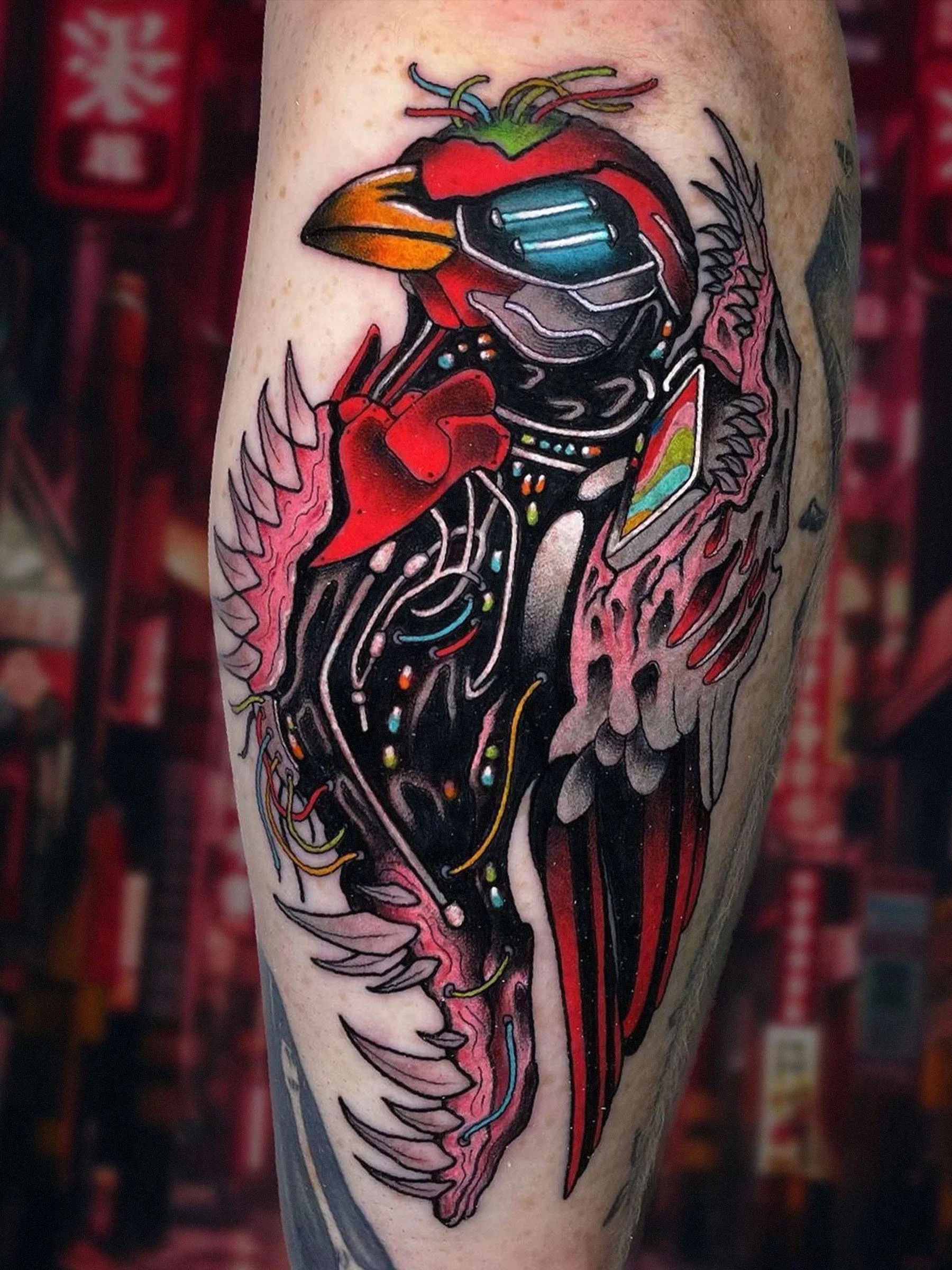 Cyberpunk cardinal bird tattoo with mechanical elements and bold color, tattoo by Evansville tattoo artist Shane Klos.