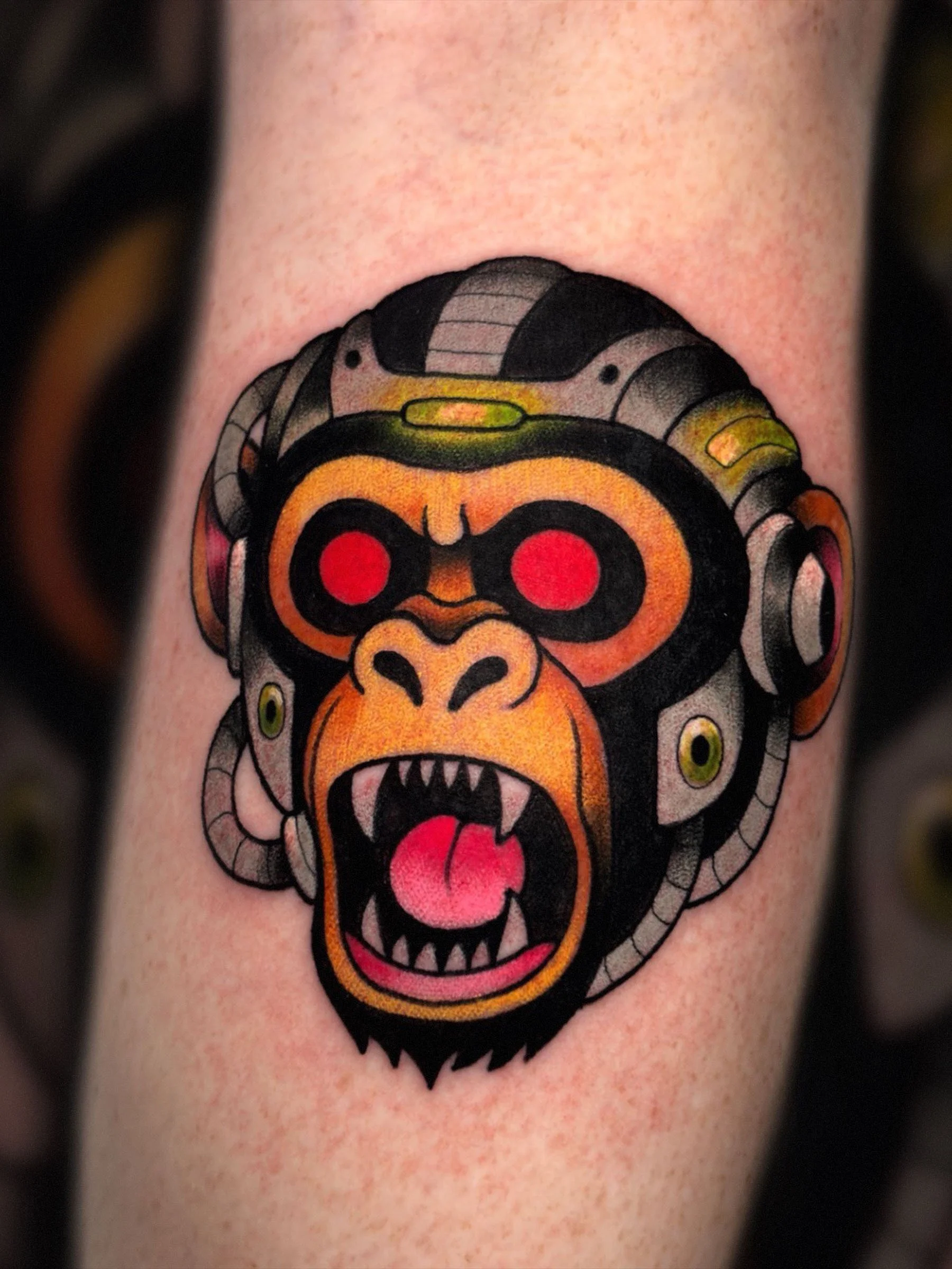 Cyber monkey head tattoo with red eyes tattooed by Shane Klos in Evansville Indiana