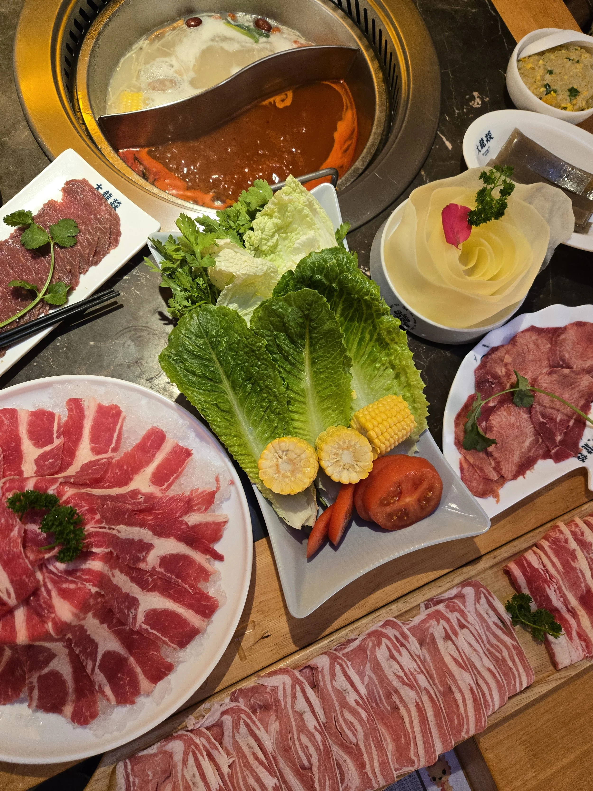An image featuring the famous volcano beef,1 meter long meat platter and hot pot at Da Long Yi in Fitzrovia