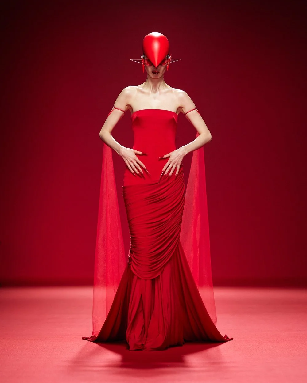 robert-wun-runway-haute-couture-red-draped-dress-with-a-train-and-red-helmet.jpg