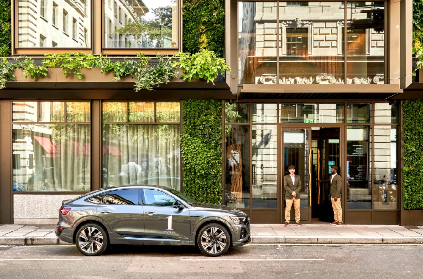 The lobby of 1 Hotel in Mayfair is a stunning example of modern architecture perfectly blending in with the surrounding while also looking like a living garden, featuring thousands of green shrubbery and plants