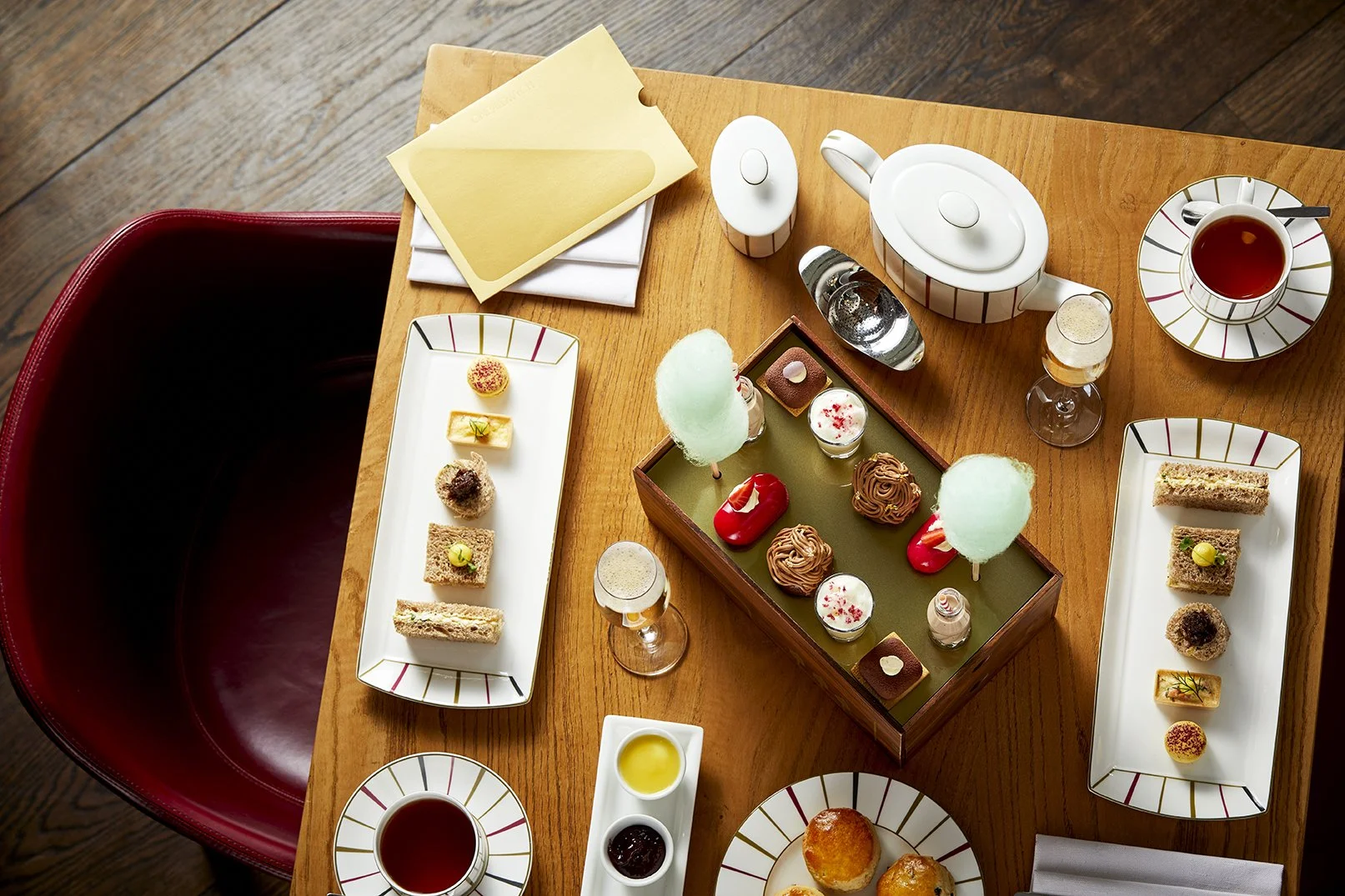 Afternoon tea table setup at One Aldwych Covent Garden London inspired by Charlie and the Chocolate Factory themed desserts and sweets
