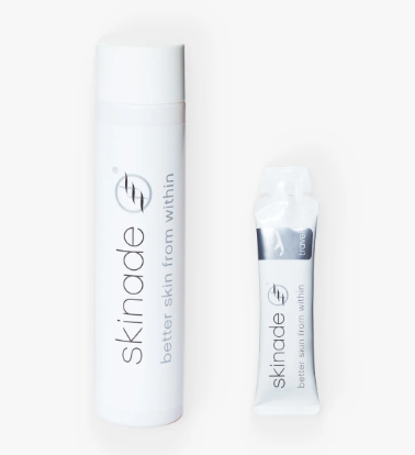 A tube and a bottle of Skinade skincare products on a white background.
