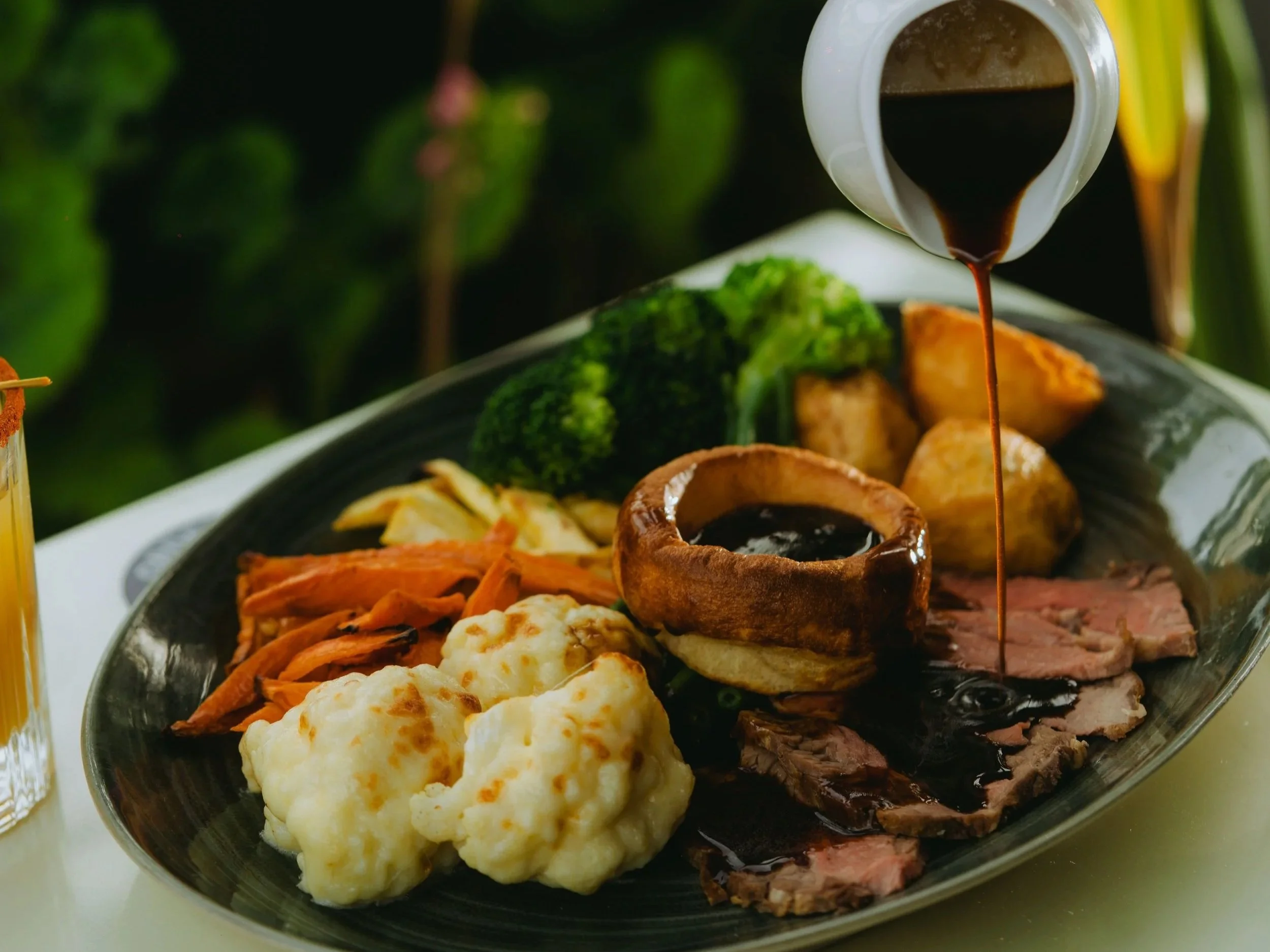 beef roast dinner with gravy pouring