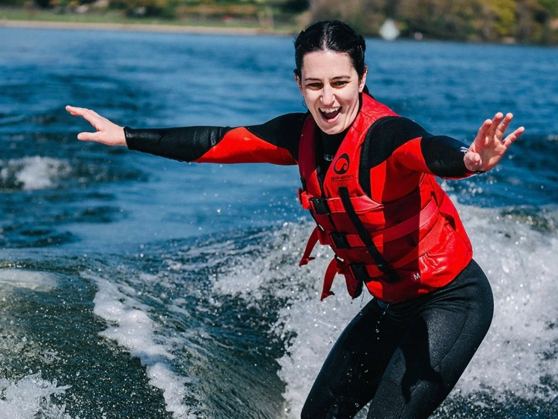 girl wakesurfing with wake on the bay