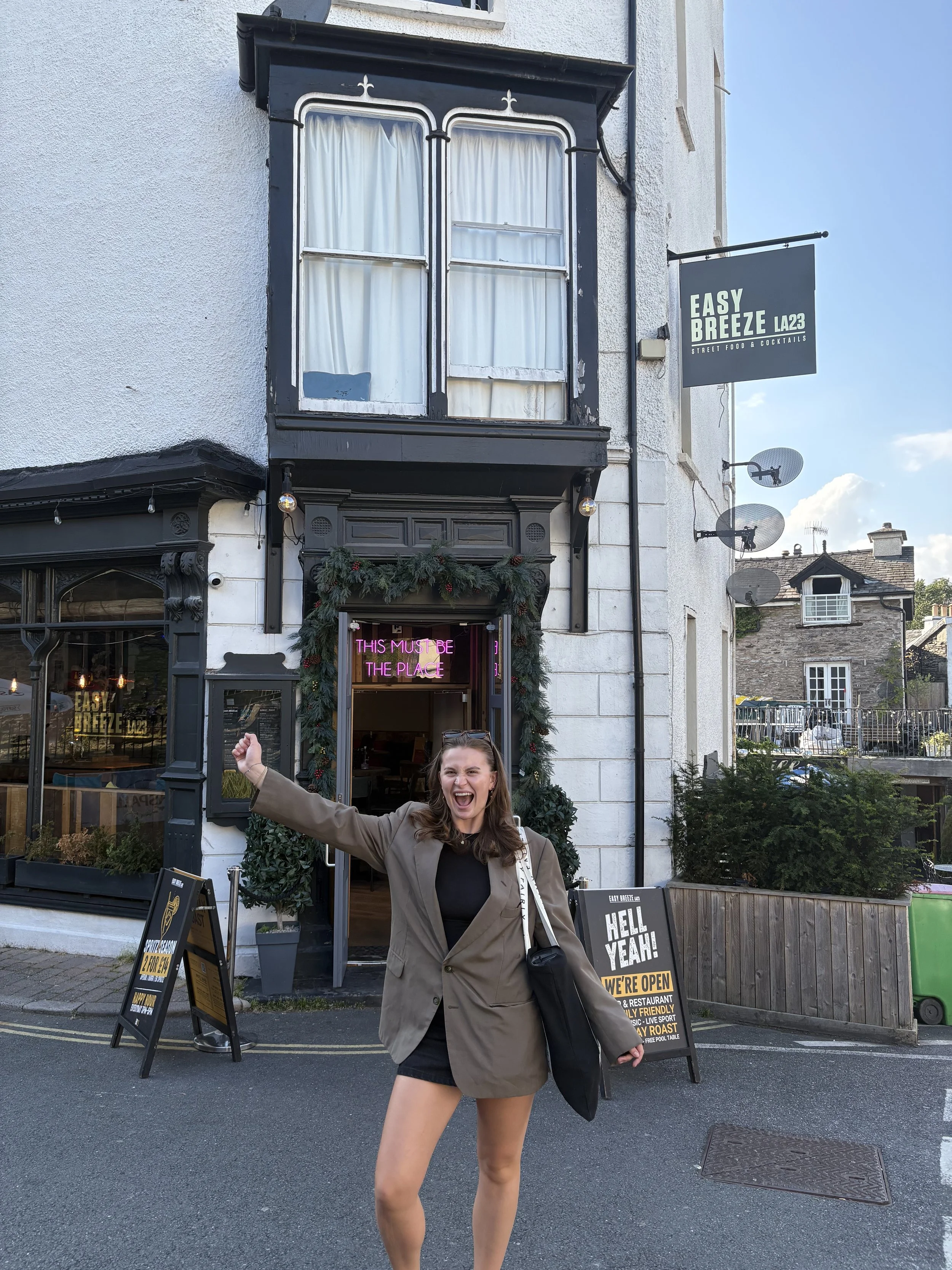 the easy breeze famous 'place to be' neon sign with happy customer