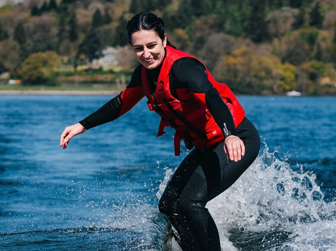girl wakesurfing on lake windermere