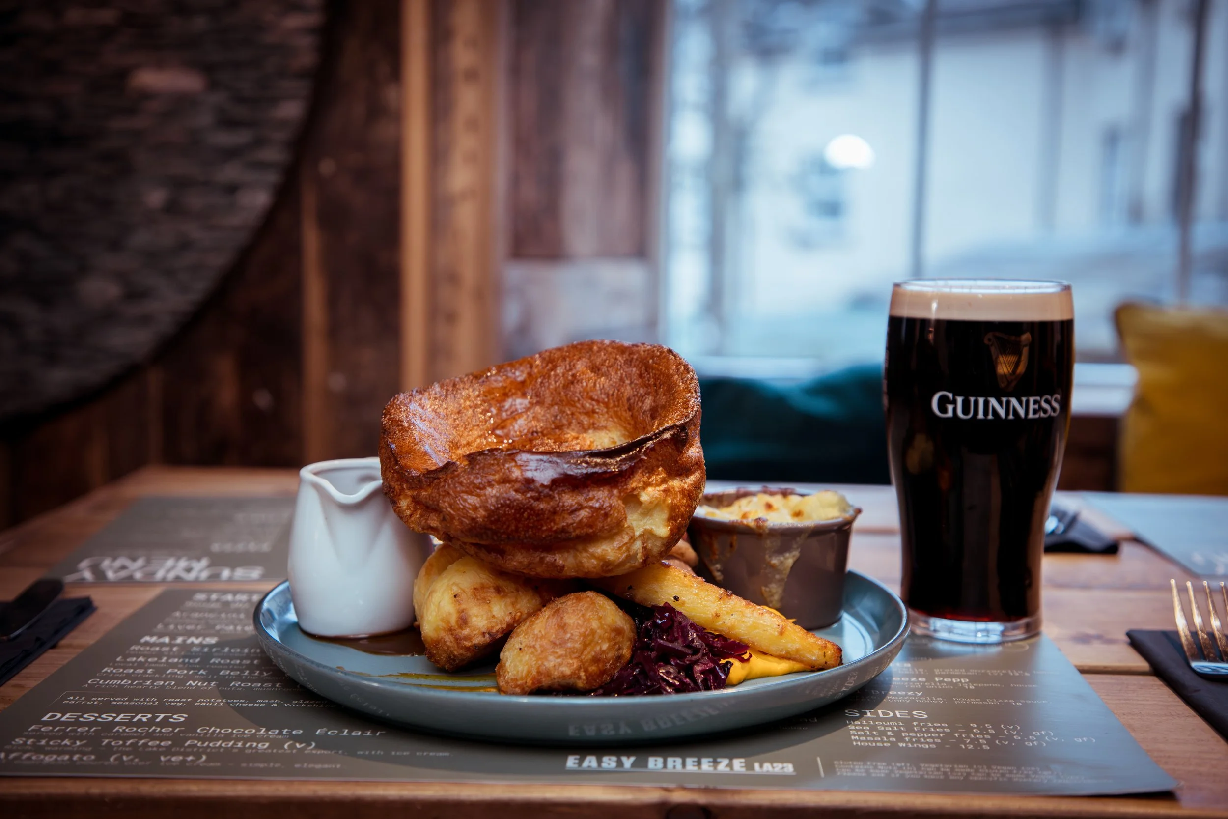 roast dinner with roast potatoes, mash, glazed carrot, seasonal veg, cauli cheese & Yorkshire pudding and gravy.
