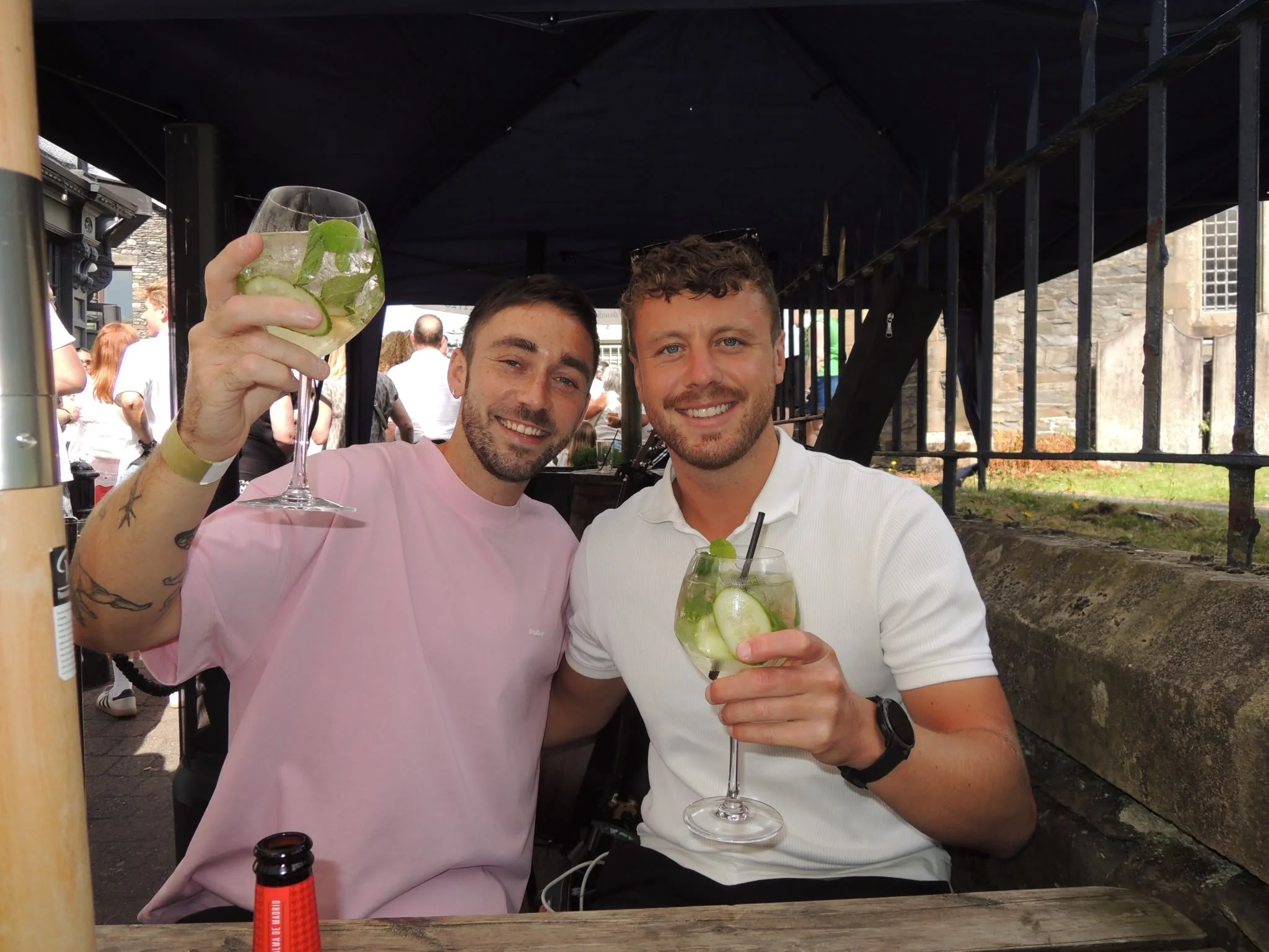 boys cheersing spritz cocktails at the easy breeze