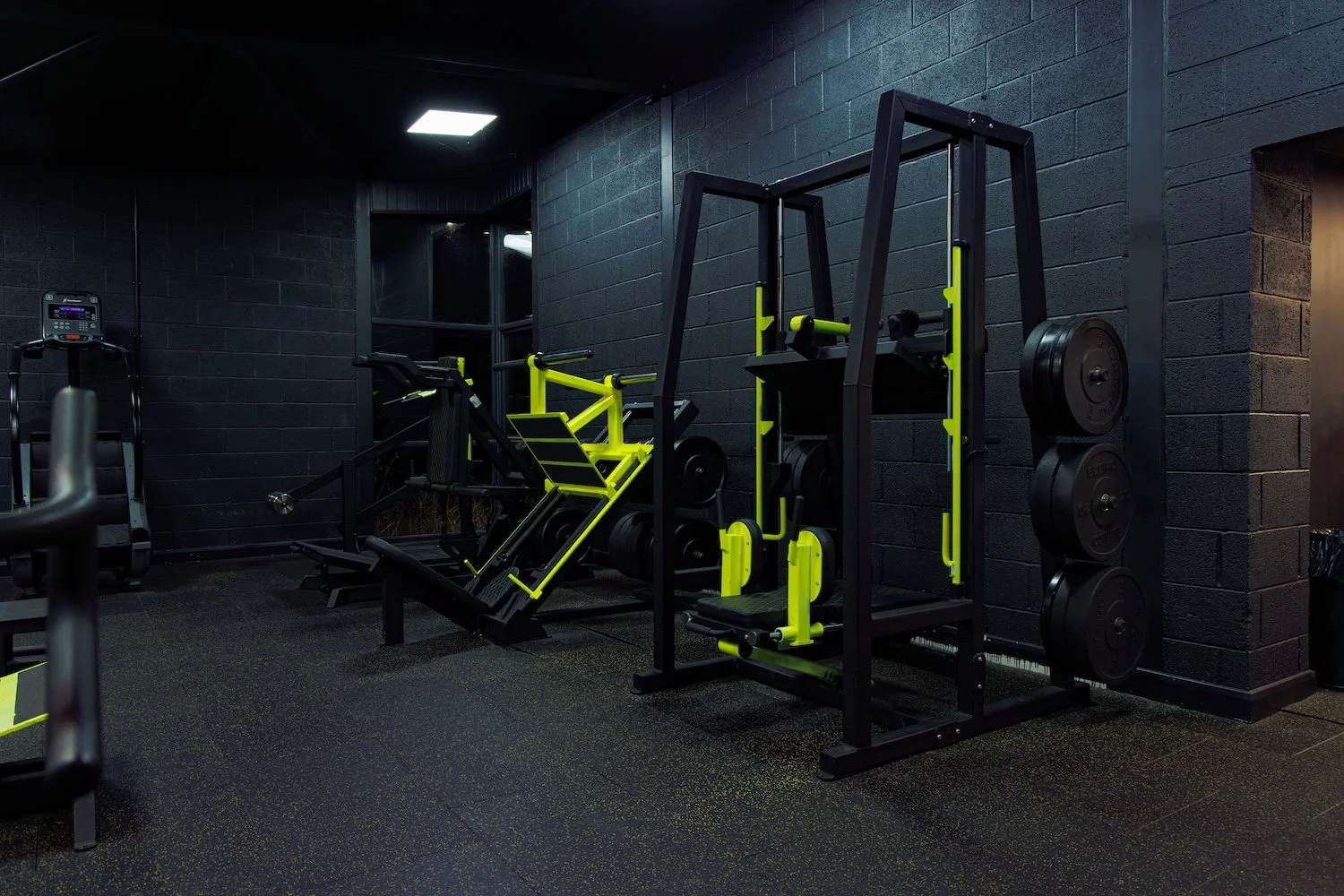 Black and yellow state of the art gym equipment at Alpha Athletic Gym.