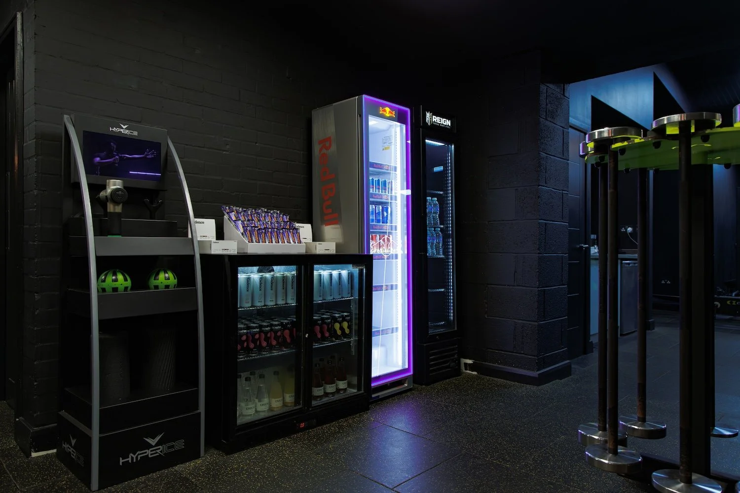 Vending machines and snacks in a dark fitness center or gym lounge area.