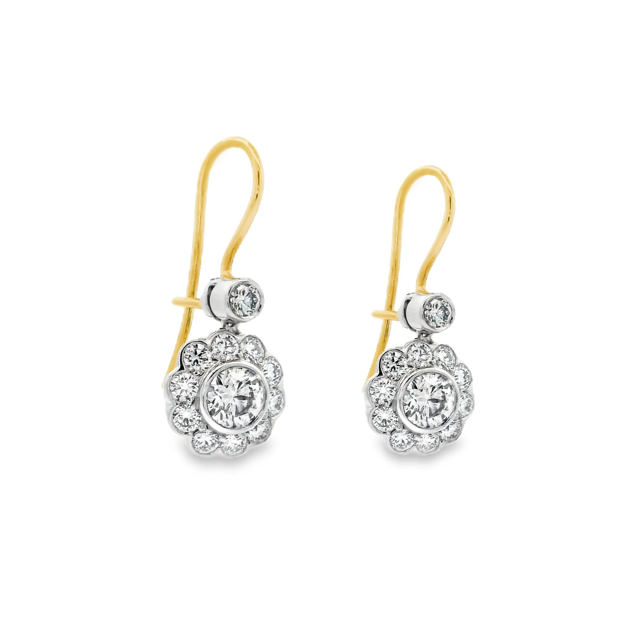 Gold and silver dangle earrings with clear rhinestones and a floral design.