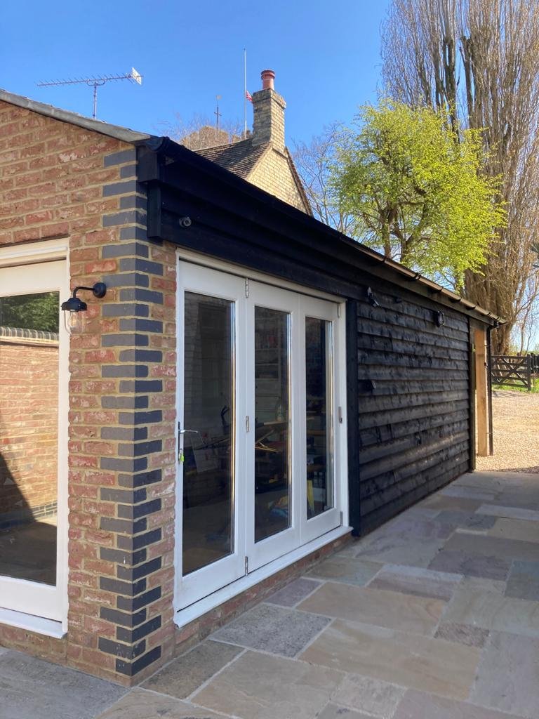 After - lots of glazing and doors for easy storage access and light.