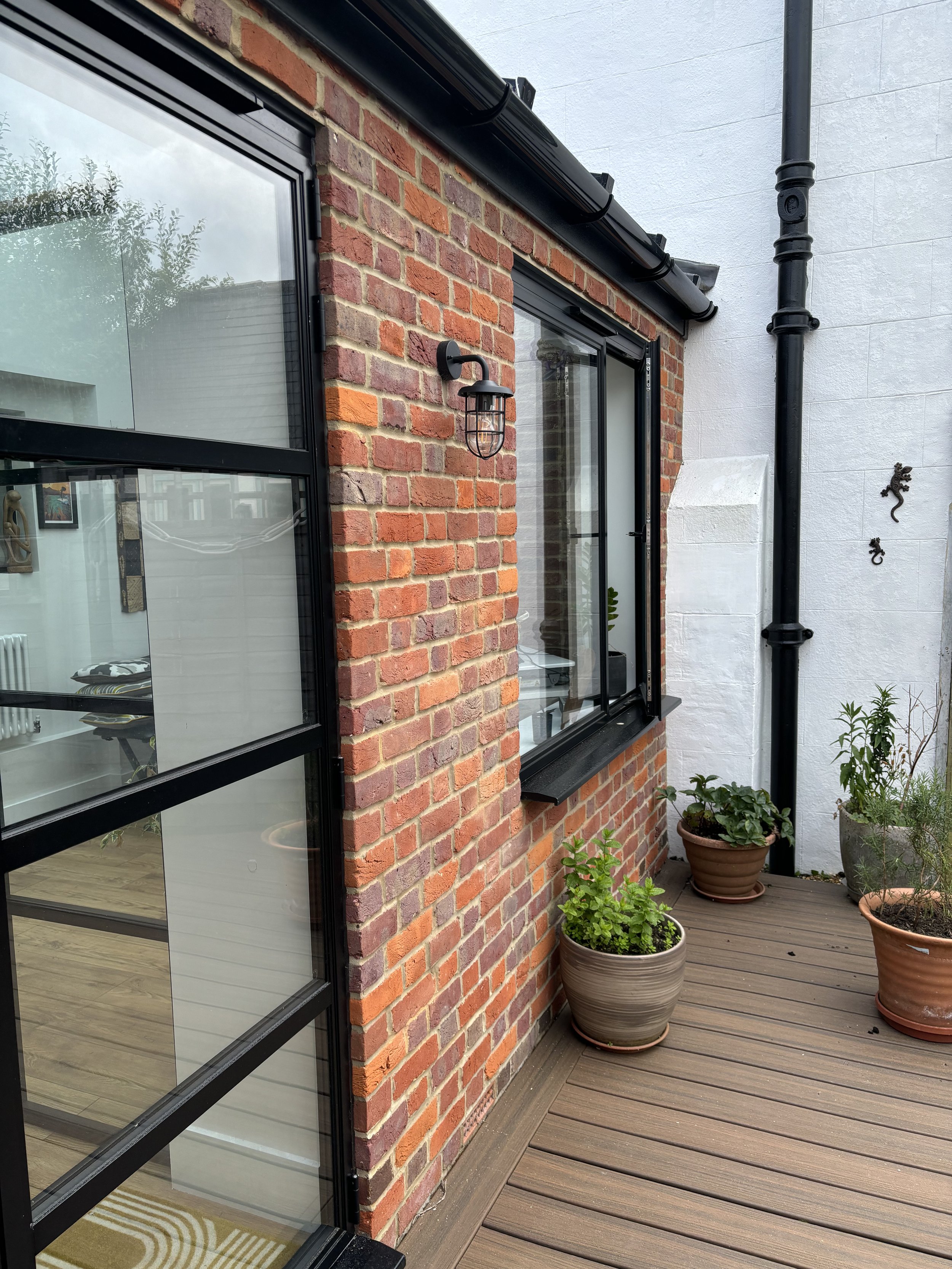 Design included brick to match the existing house and black aluminum giving a contemporary feel.