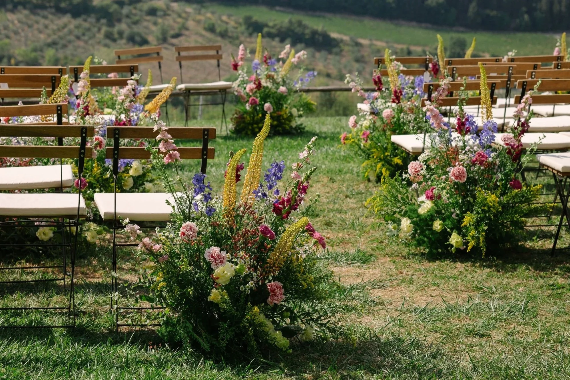aisle meadows placed next to ceremony chairs for a wedding in tuscany