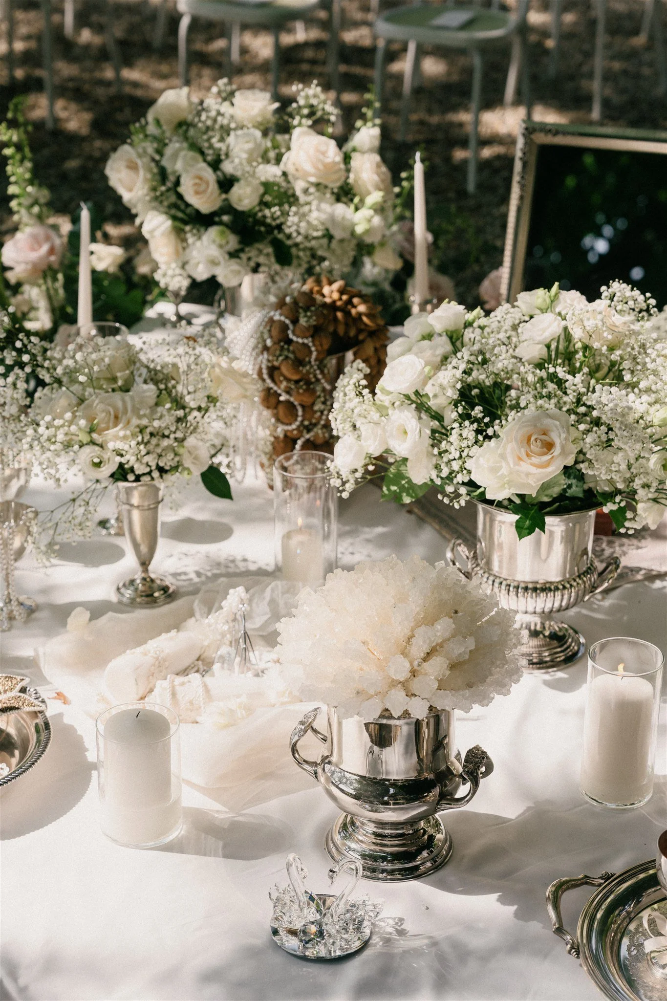 White floral arrangements surrounding Sofreh Aghd display