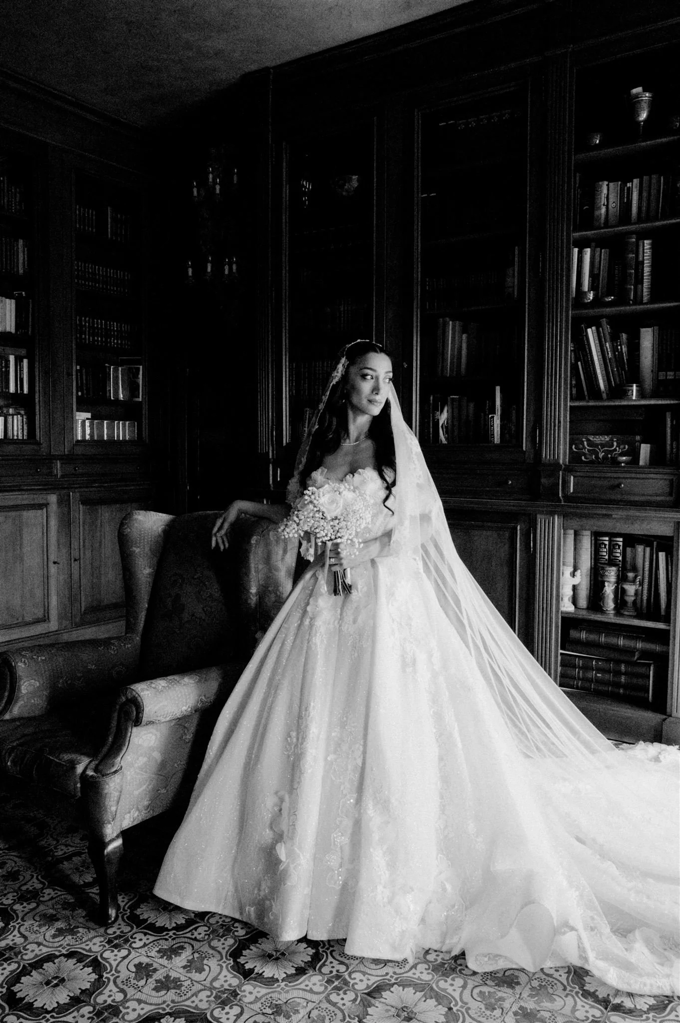 Bride in voluminous gown inside Villa Nemora library in Tuscany