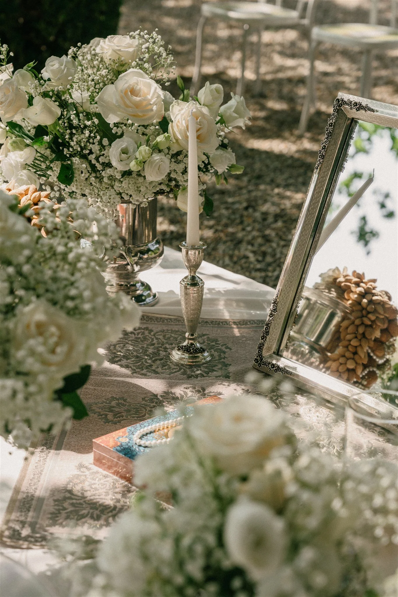 Sofreh Aghd table details with mirror, candles and white florals