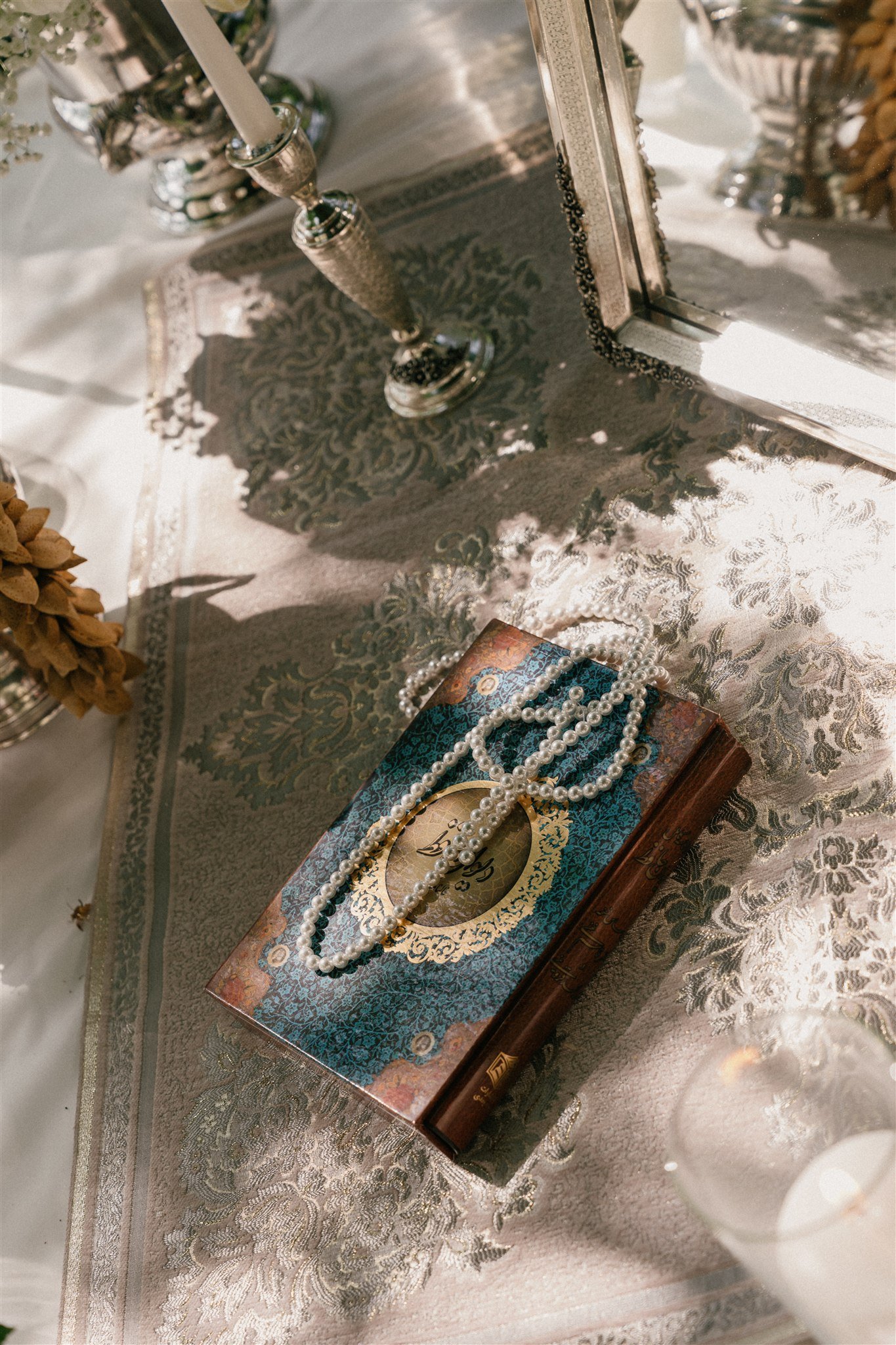 Quran with prayer beads on Persian wedding ceremony table
