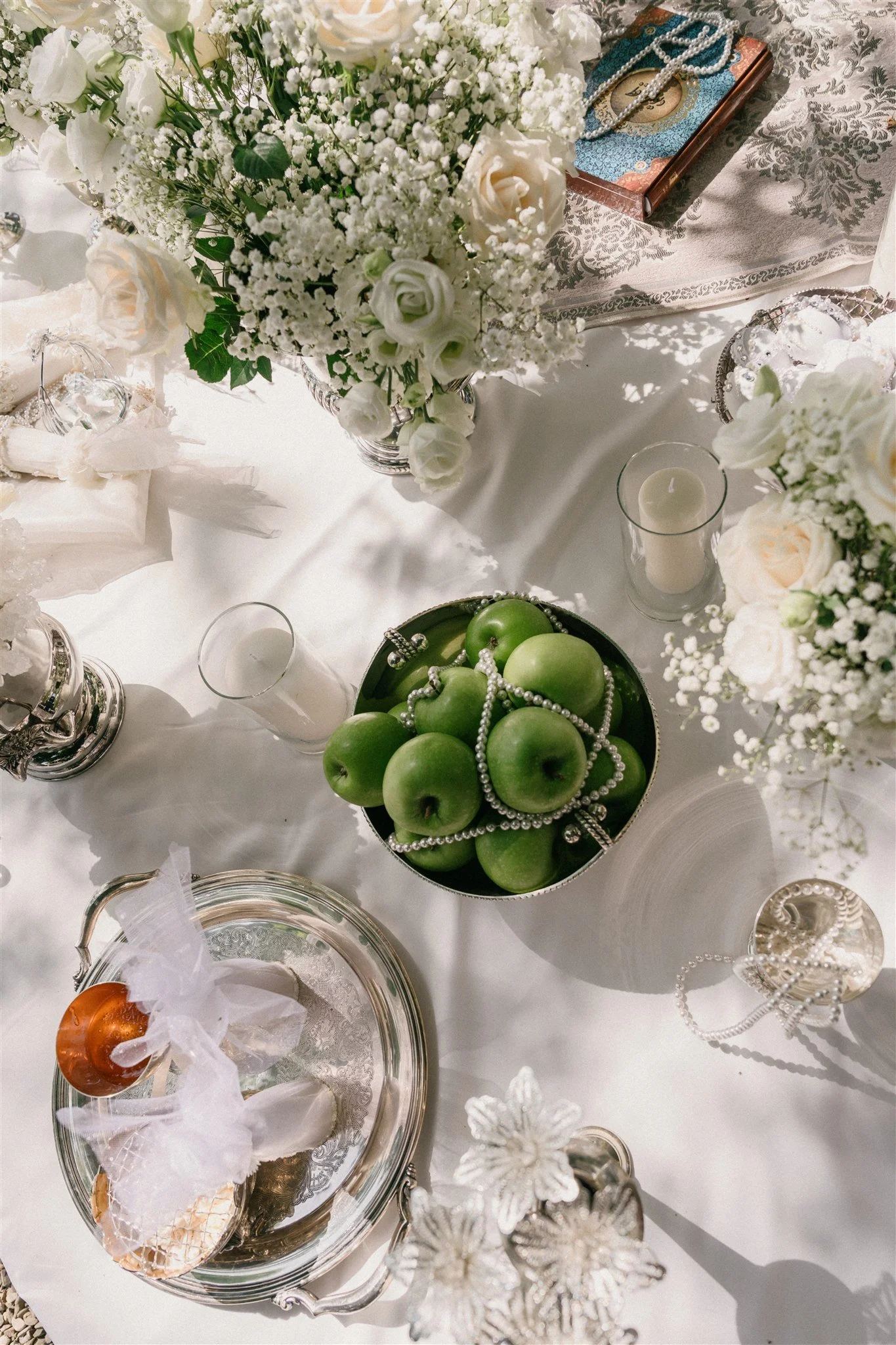 Green apples and silverware arranged on Persian ceremony table