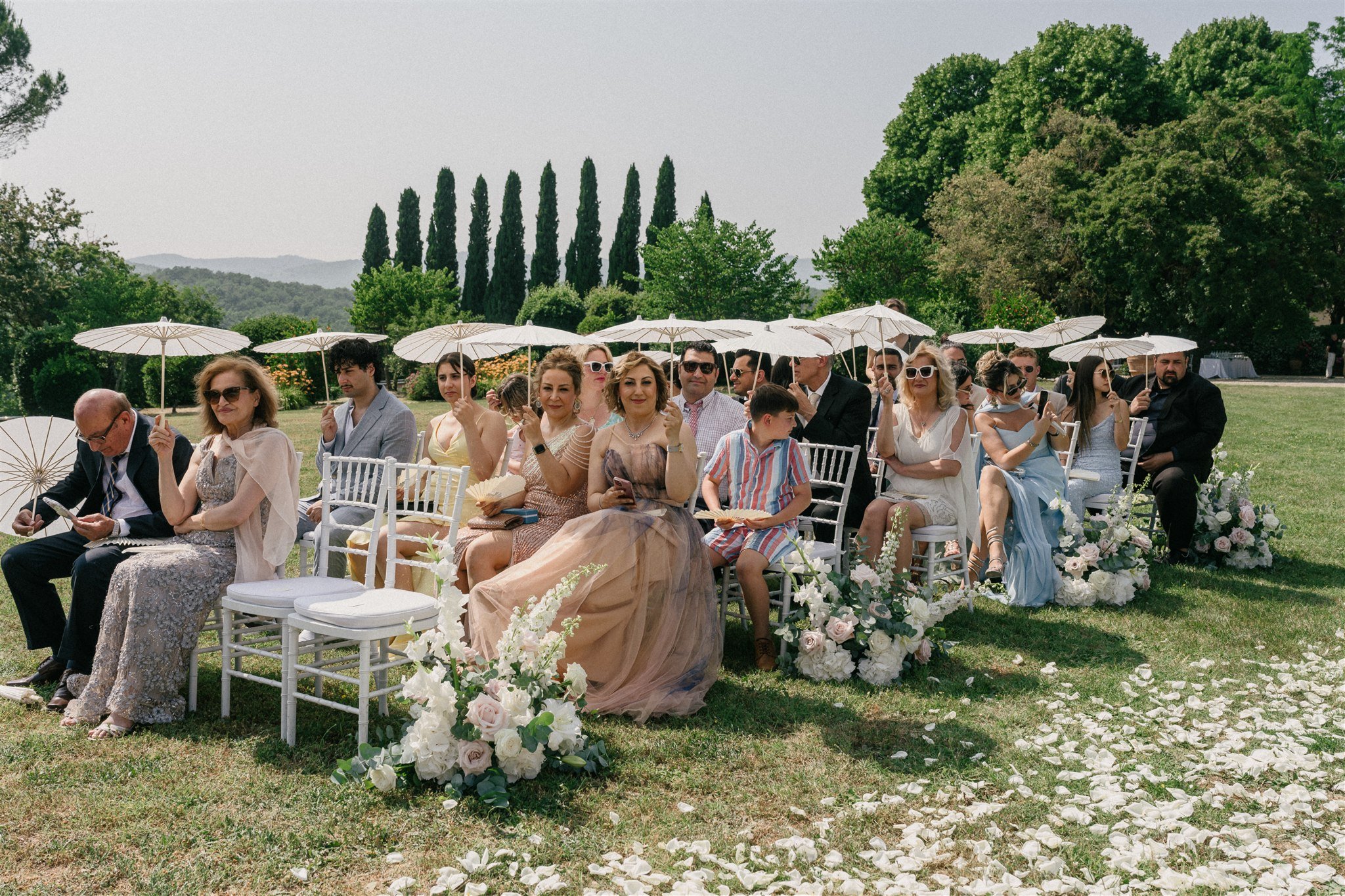Guests seated for summer wedding ceremony in Tuscany
